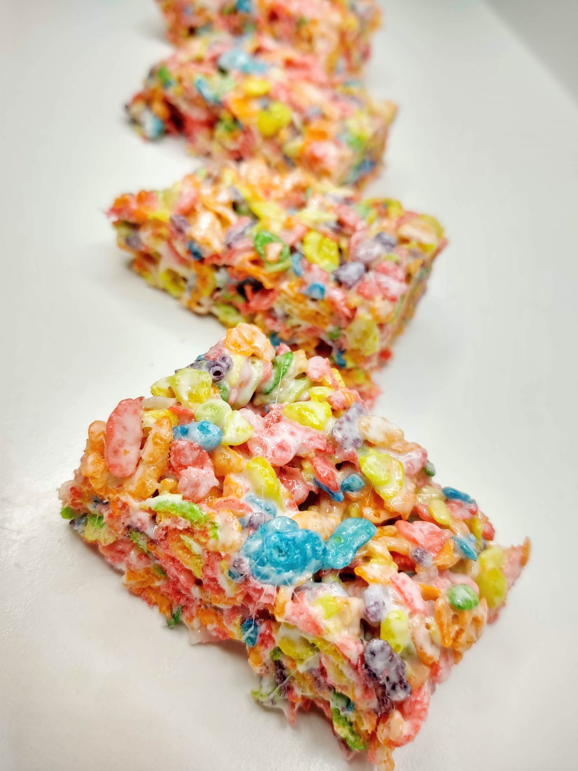 Fruity Pebble Rice Krispie Treats laying on a counter