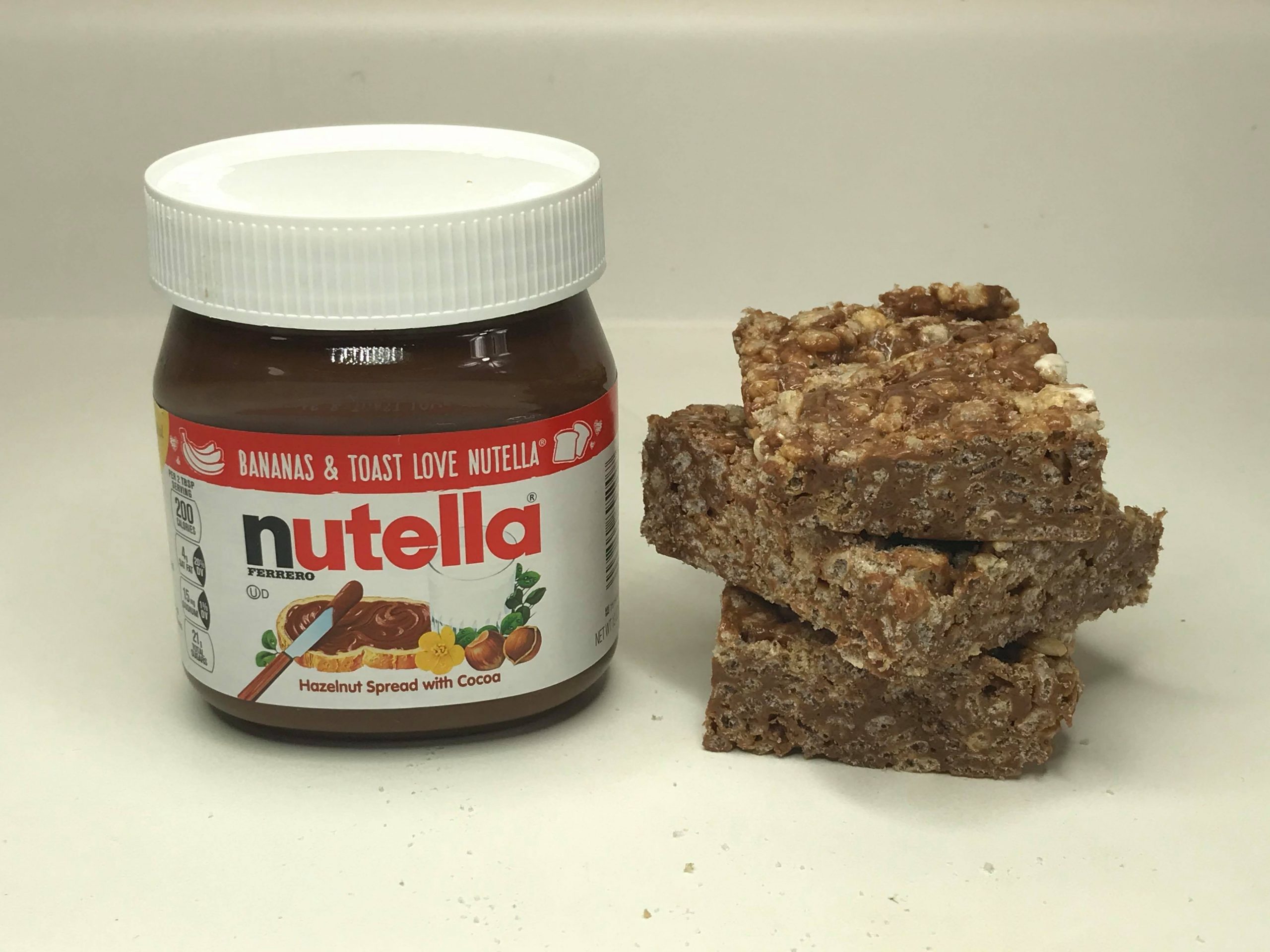 nutella rice krispie treats with jar of nutella next to them