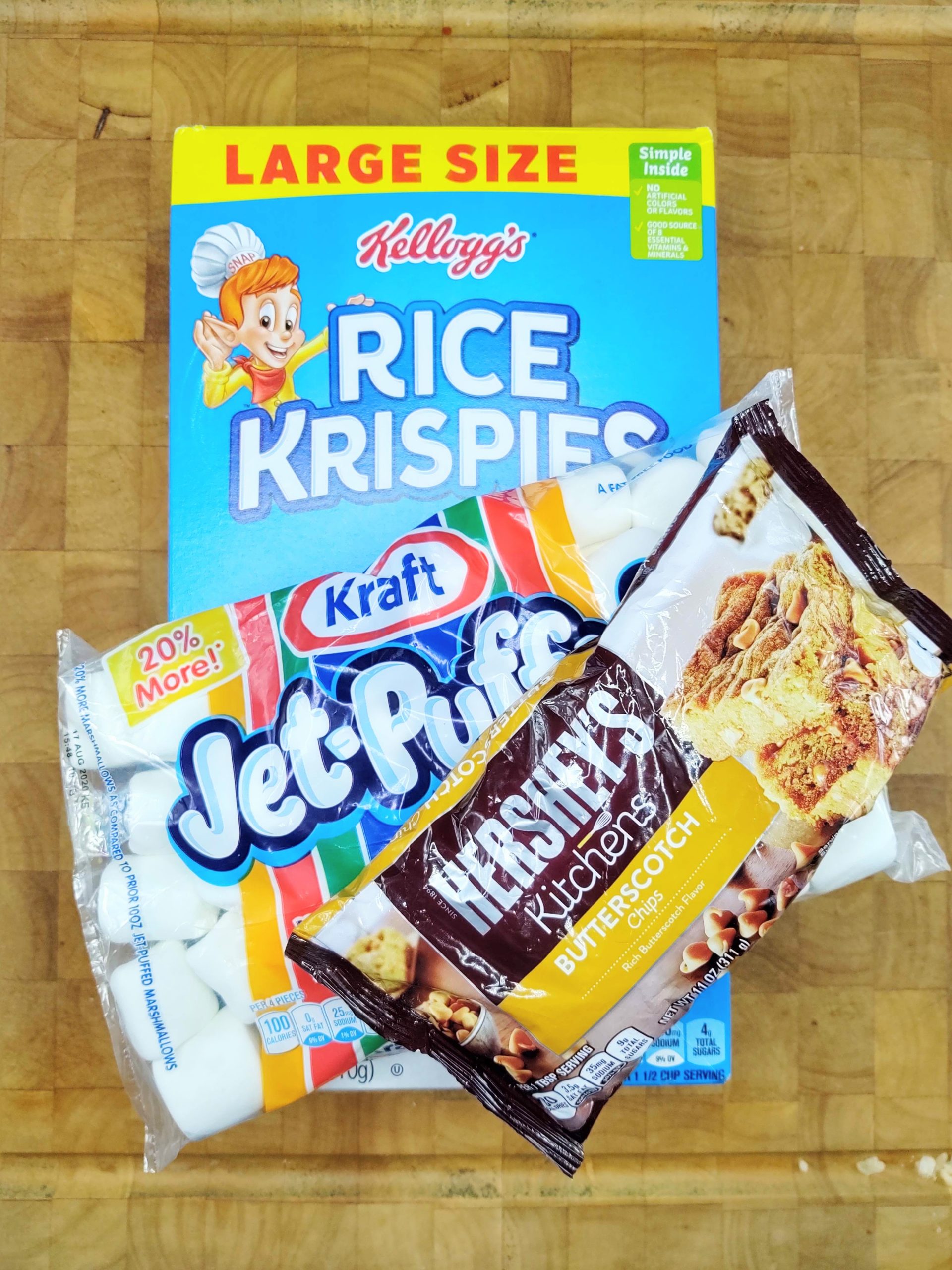 box of Rice Krispies, bag of Jet Puff marshmallows, a bag of Hershey's butterscotch chips