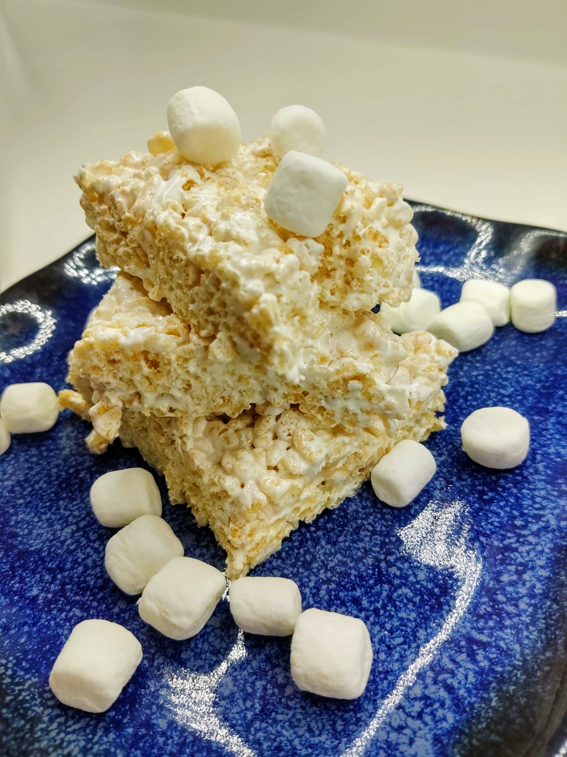 closeup of marshmallow fluff rice krispie treats surrounded by mini marshmallows