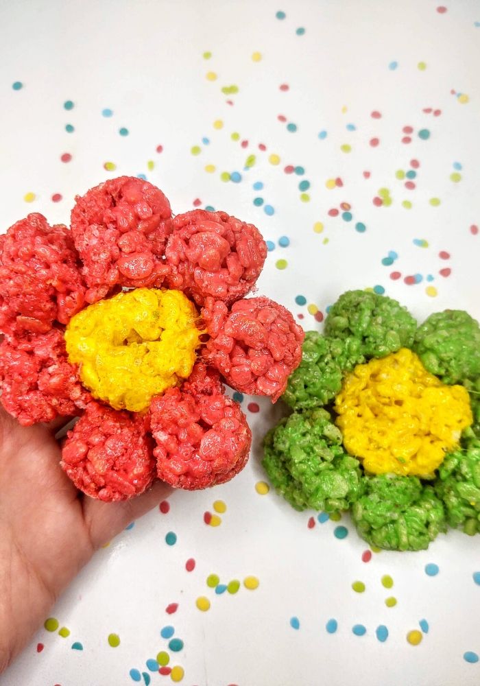 2 flower rice krispie treats. one with green petals and one with red petals