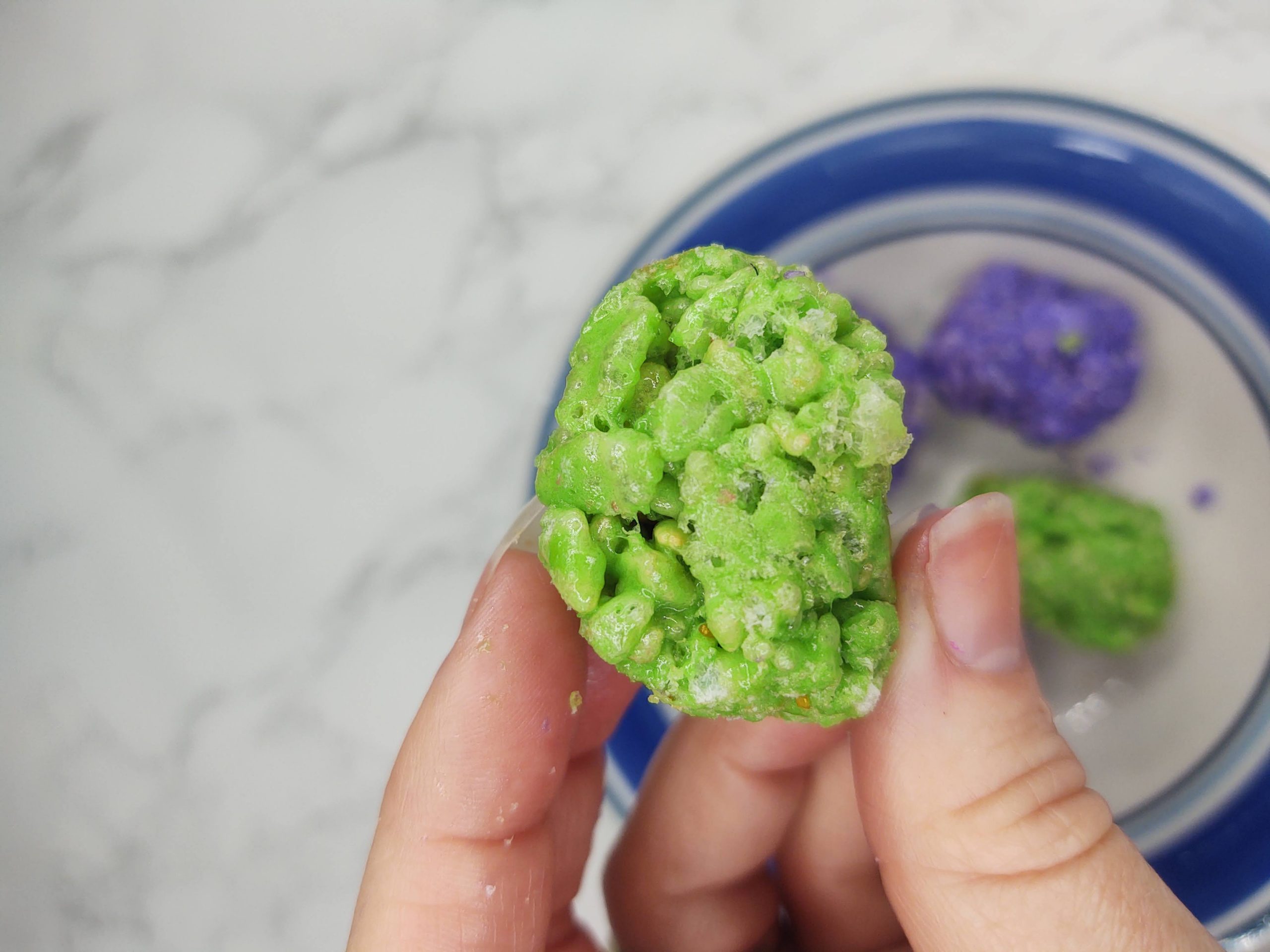 green dinosaur egg treat being held