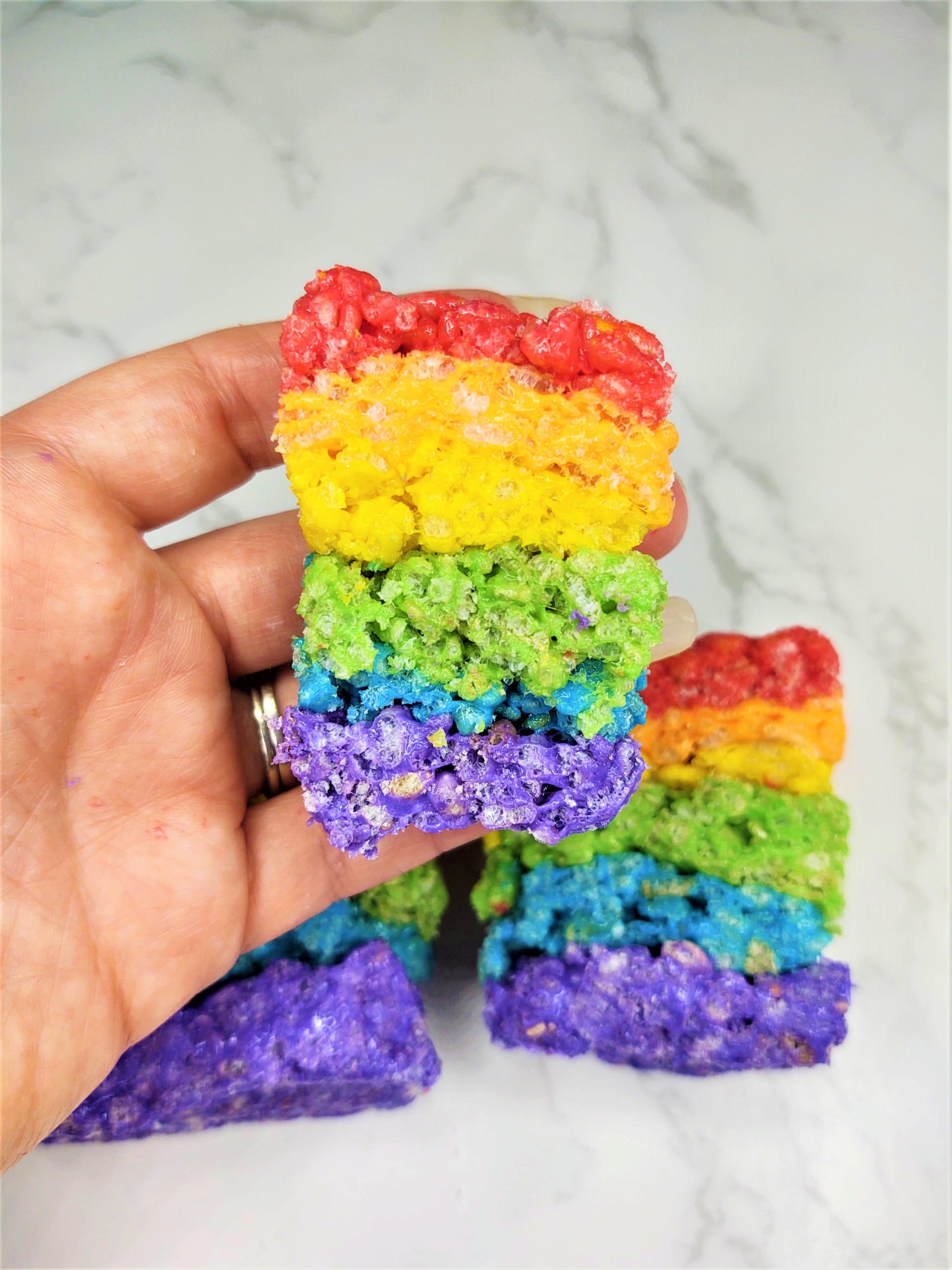 Rainbow Rice Krispie Treats being held in a hand