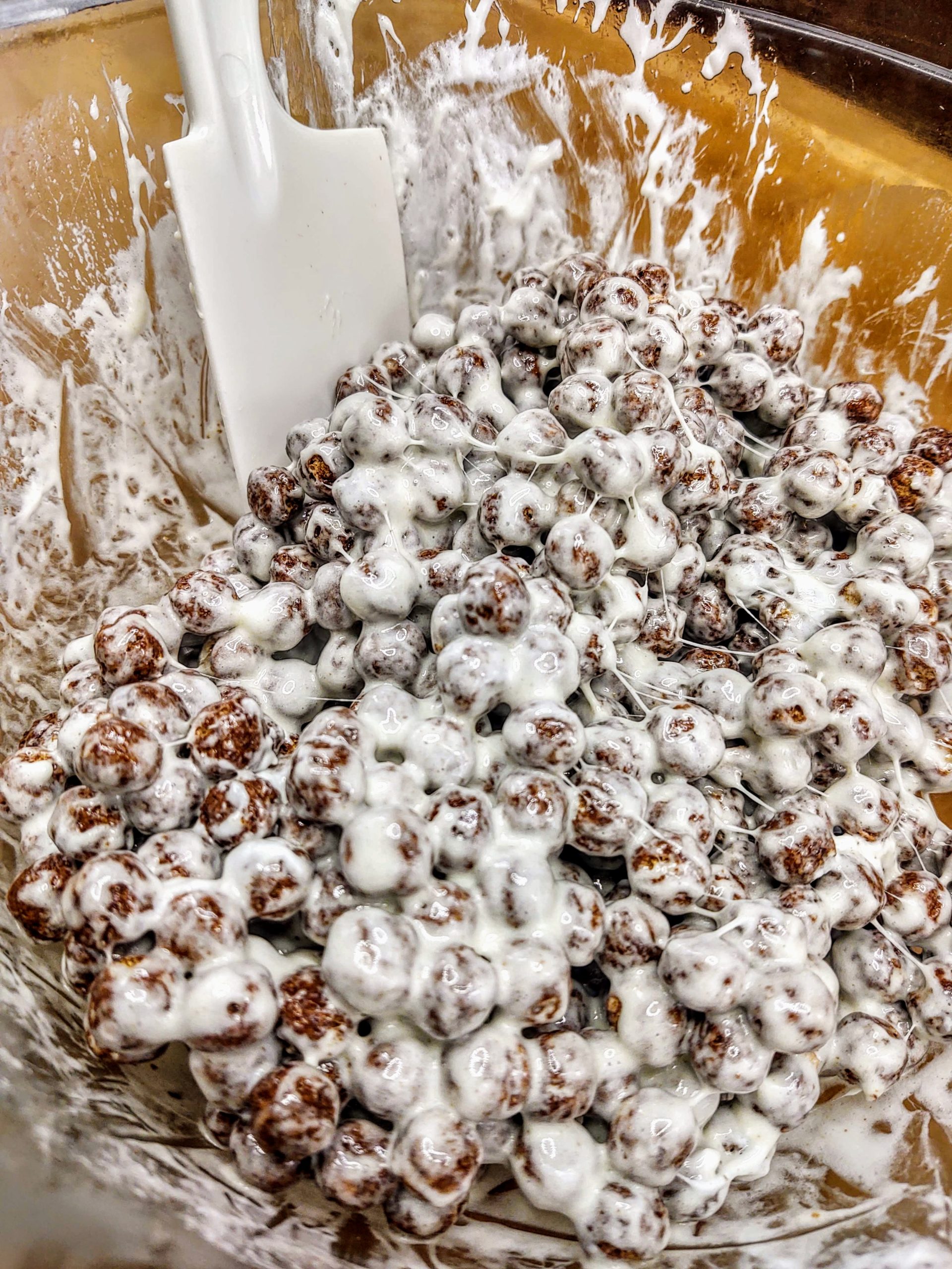 cocoa puffs mixed with marshmallows in glass bowl