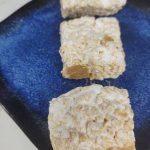 caramel rice krispie treats on a blue plate