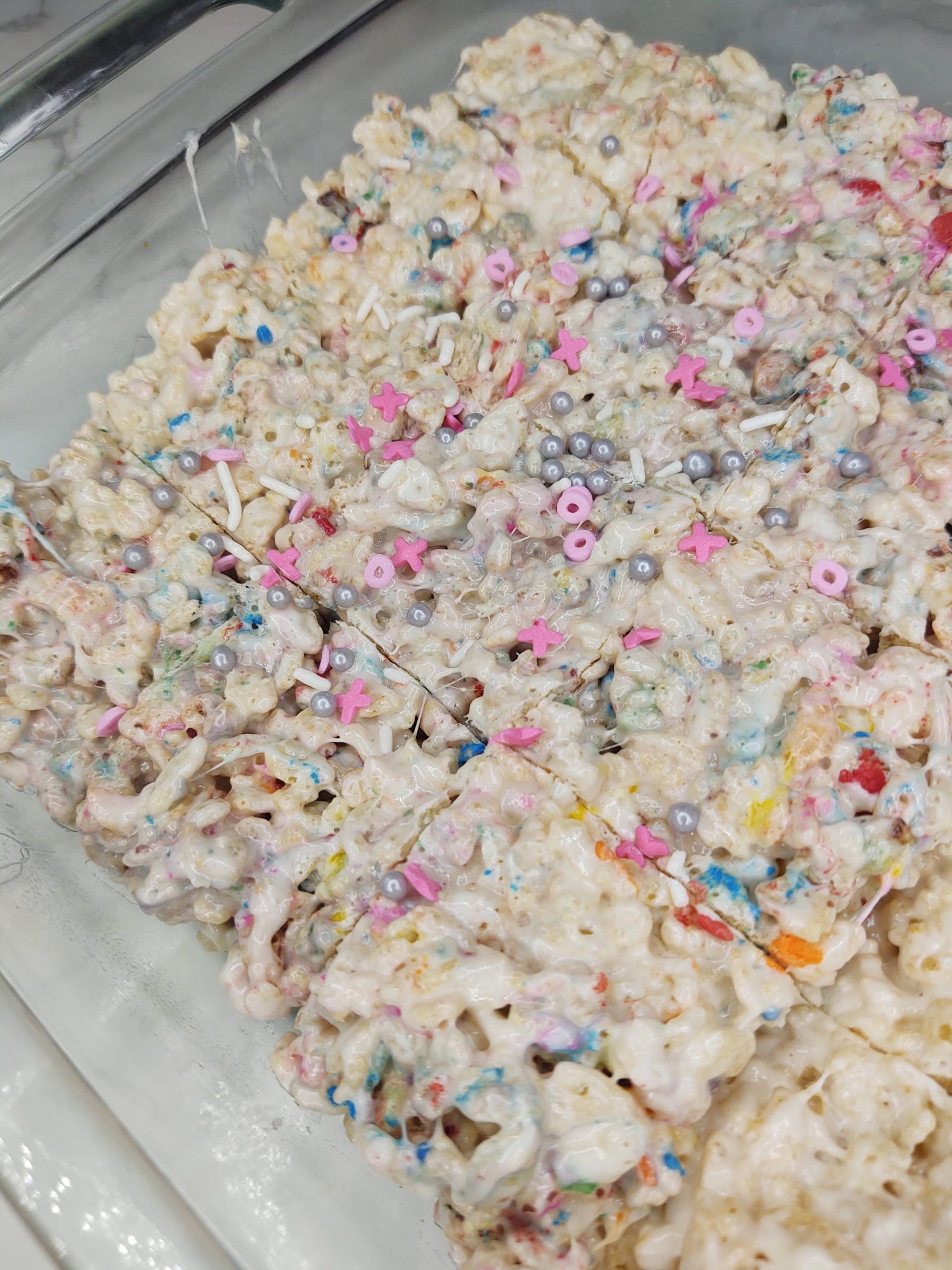 cutting rice krispie treats with sprinkles