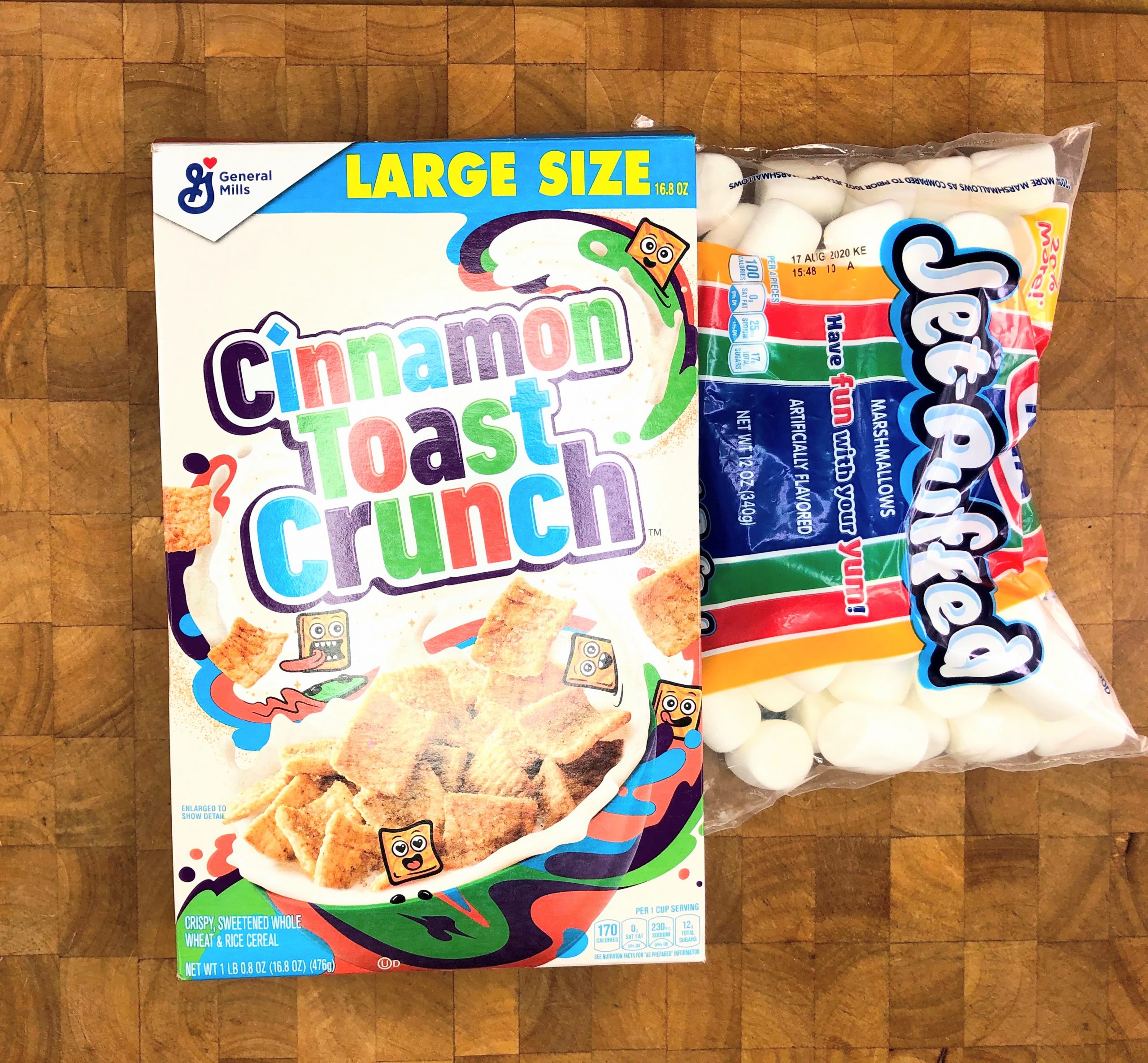 box of cinnamon toast crunch and a bag of marshmallows on a wooden table