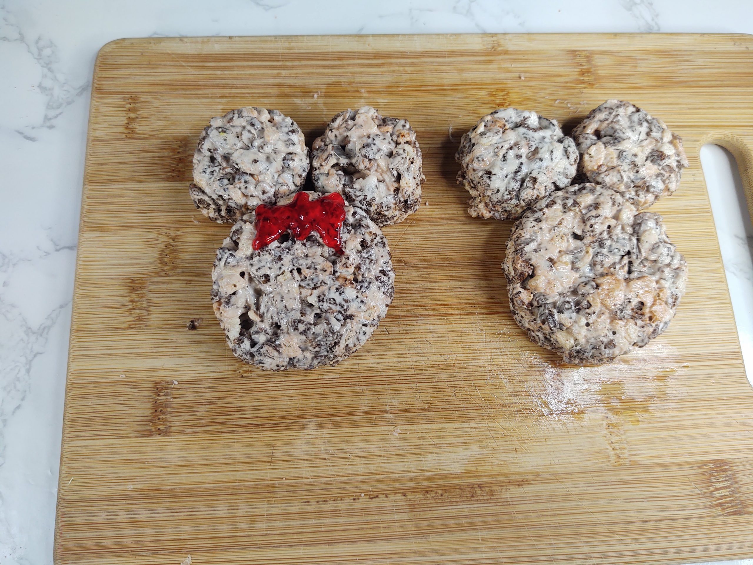 adding the bows to minnie mouse rice krispie treats