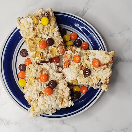 three reeses pieces rice krispie treats on a plate