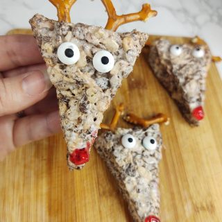 closeup of reindeer rice krispie treat with two others in background on cutting board