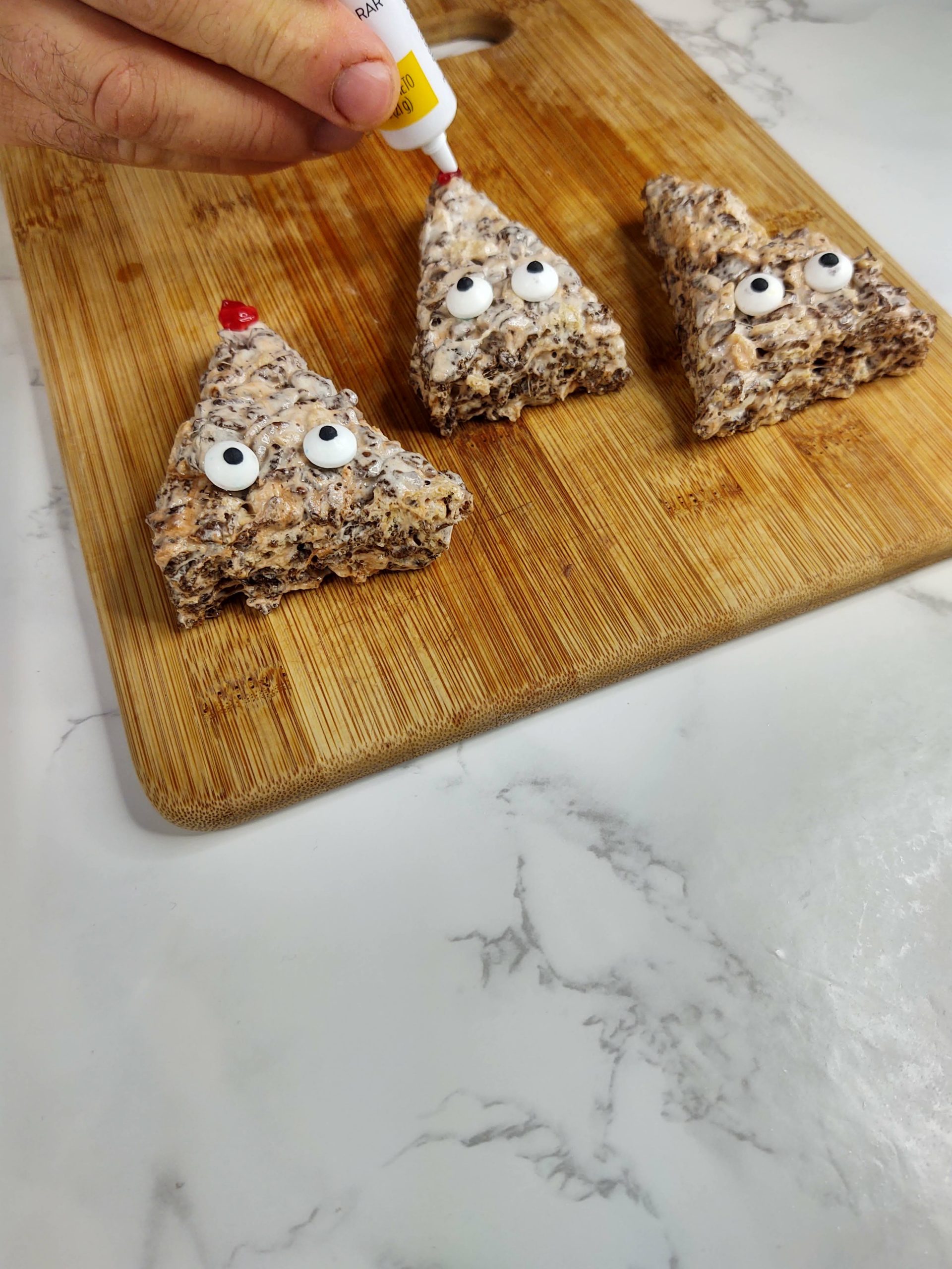 adding red nose to reindeer rice krispie treats