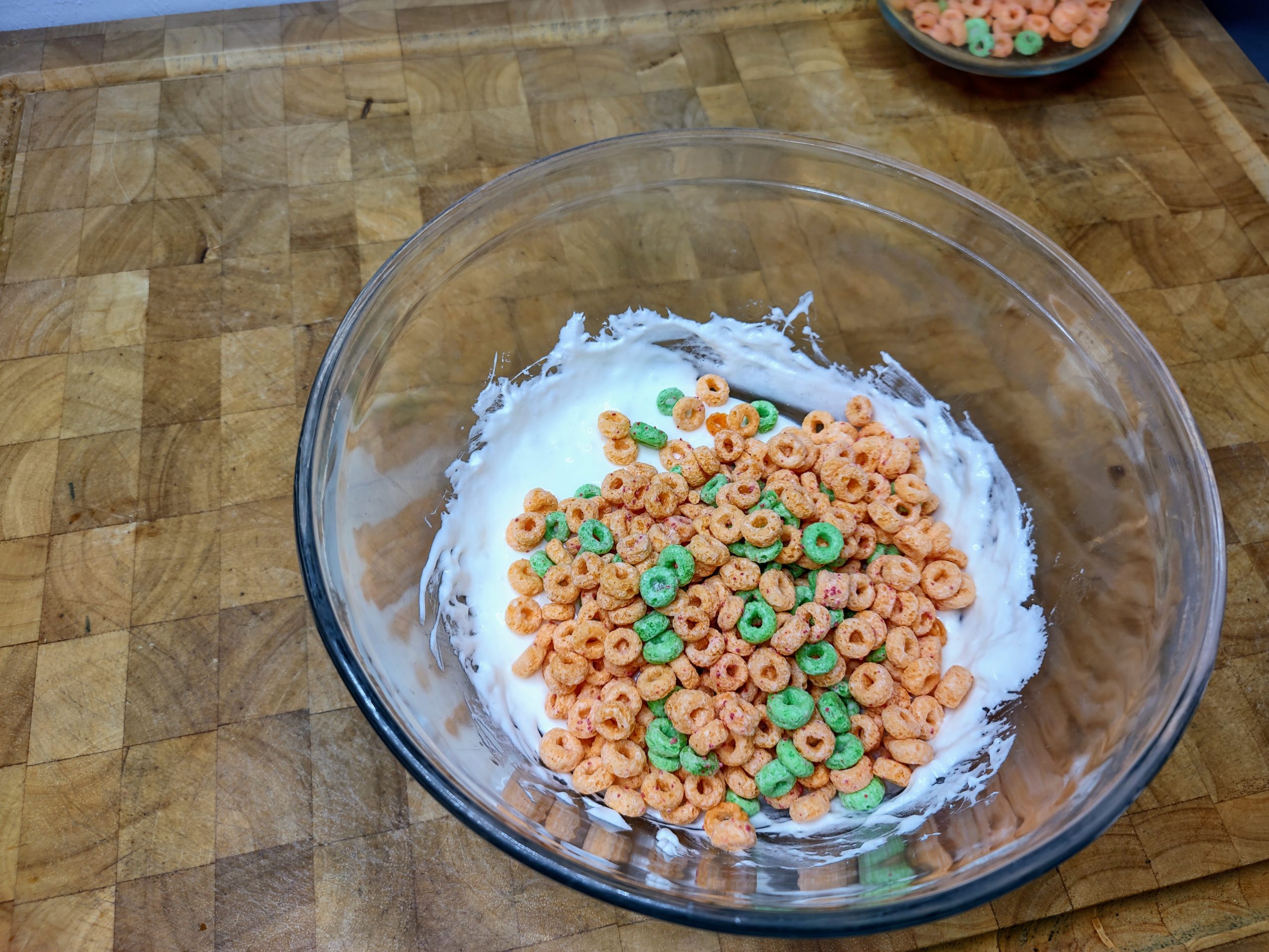 pouring cereal into melted marshmallows