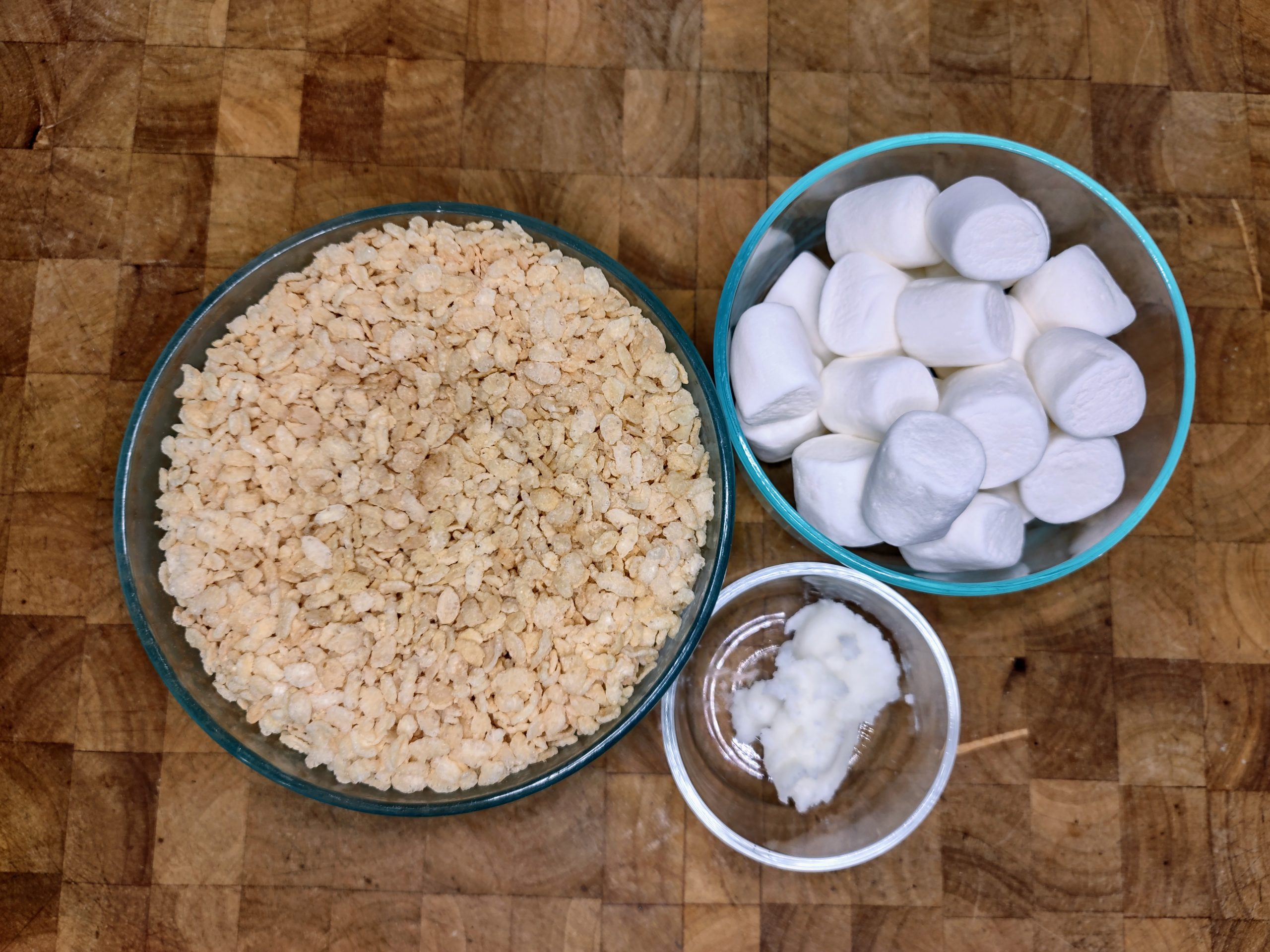 bowls of coconut oil, marshmallows and rice krispie cereal