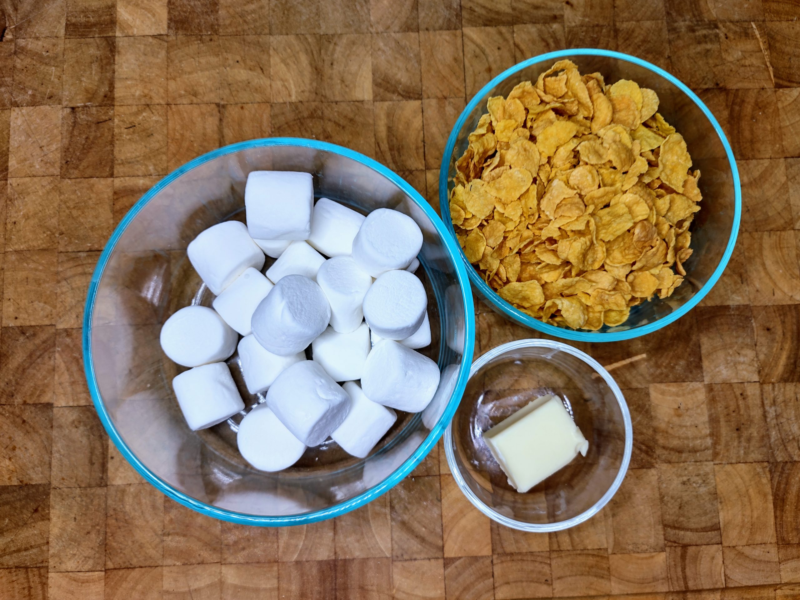 bowls of corn flakes, marshmallows and butter