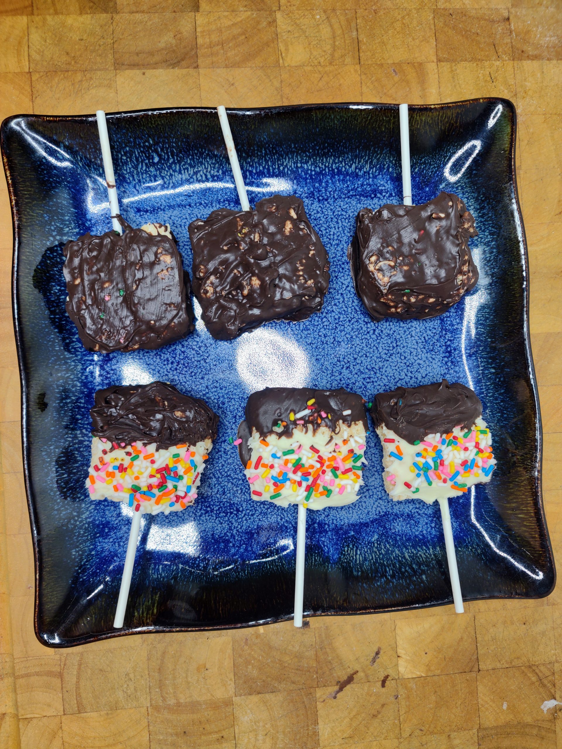 blue plate with six chocolate dipped ricr krispie treats