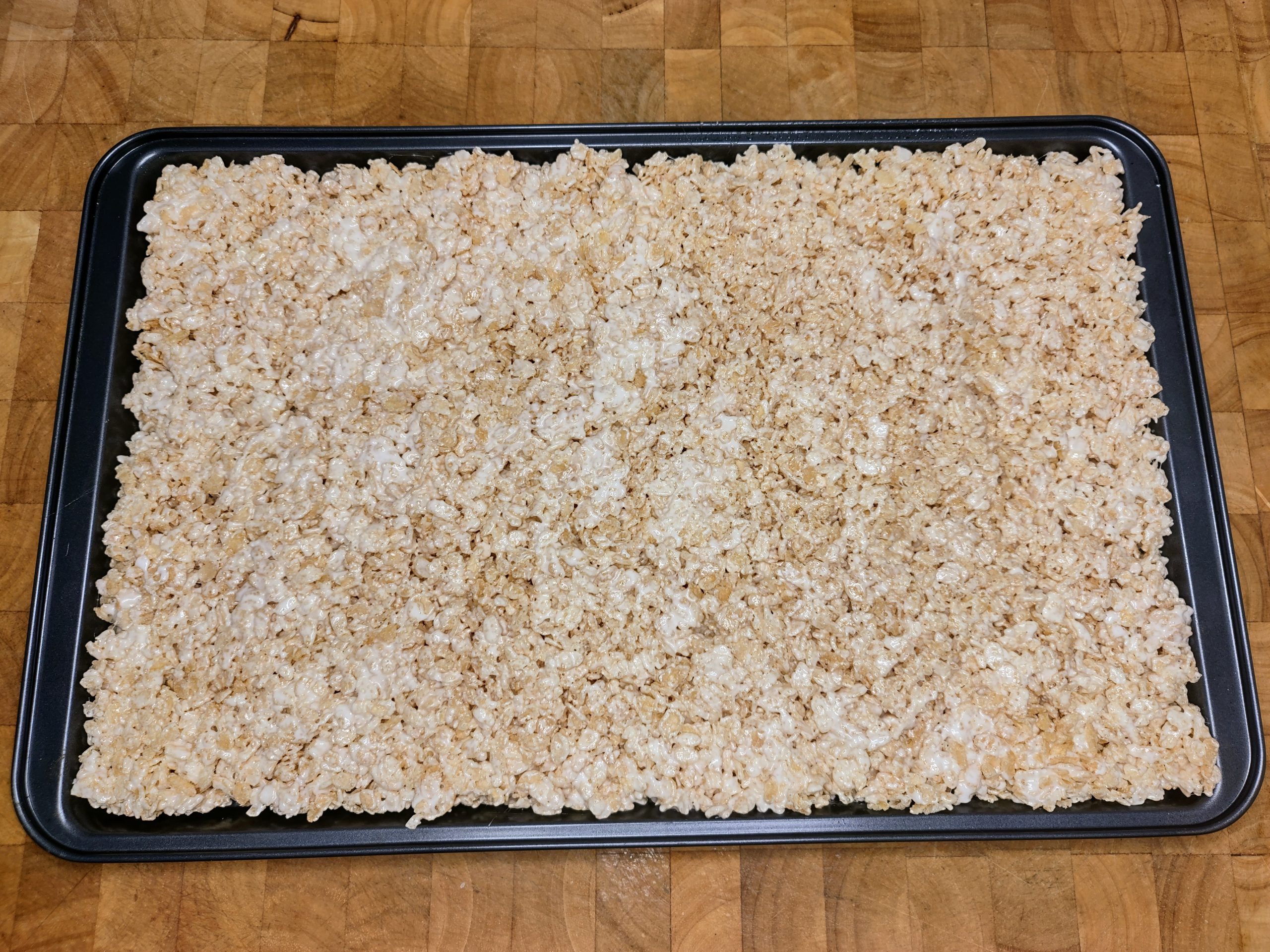 giant rice krispie treat on a cookie sheet