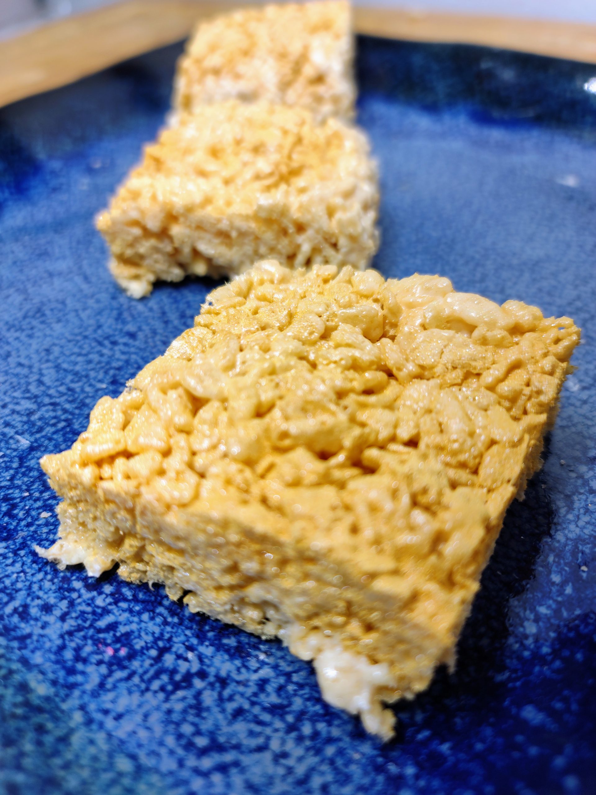 plate of three gold rice krispie treats