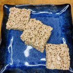 three honey nut cheerio bars on a blue plate