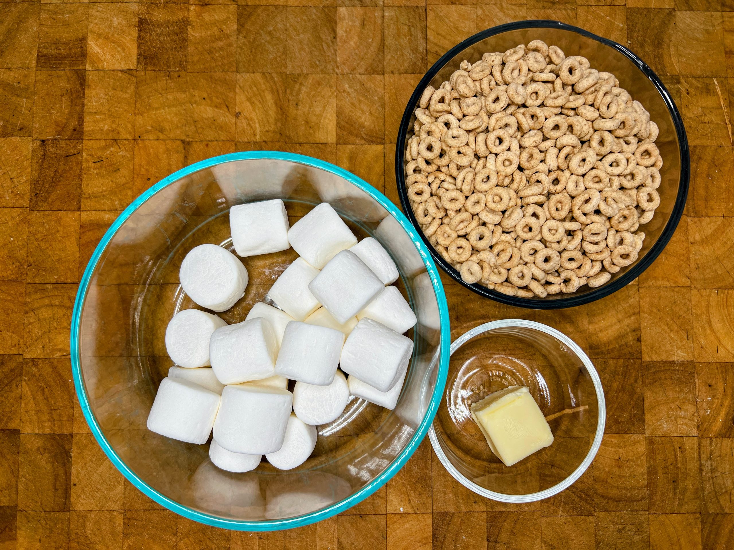 bowls of honey nut cheerios, butter and marshmallows