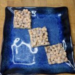 three reeses puffs treats on a blue plate