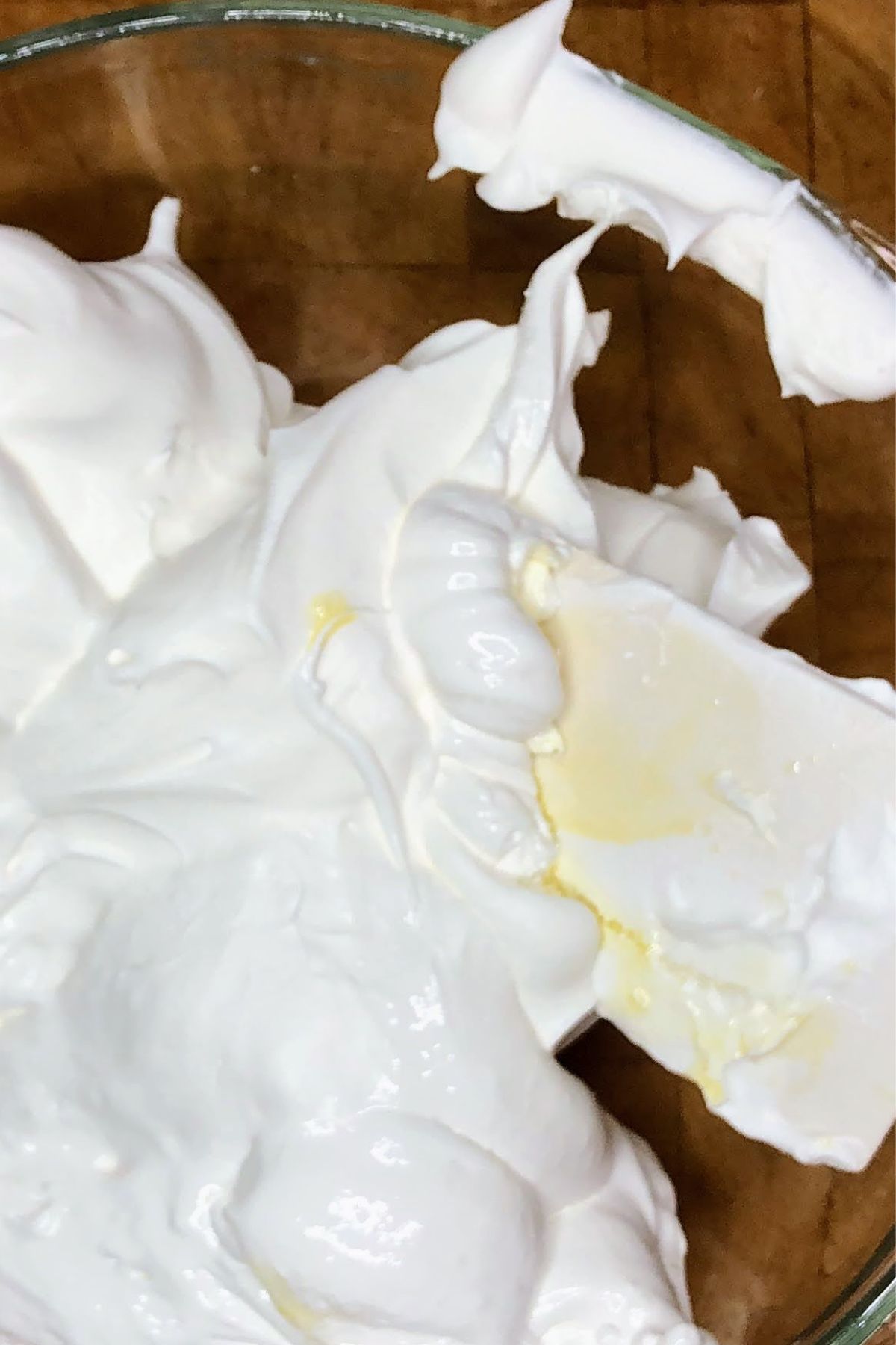 Folding marshmallow fluff into whipped topping.