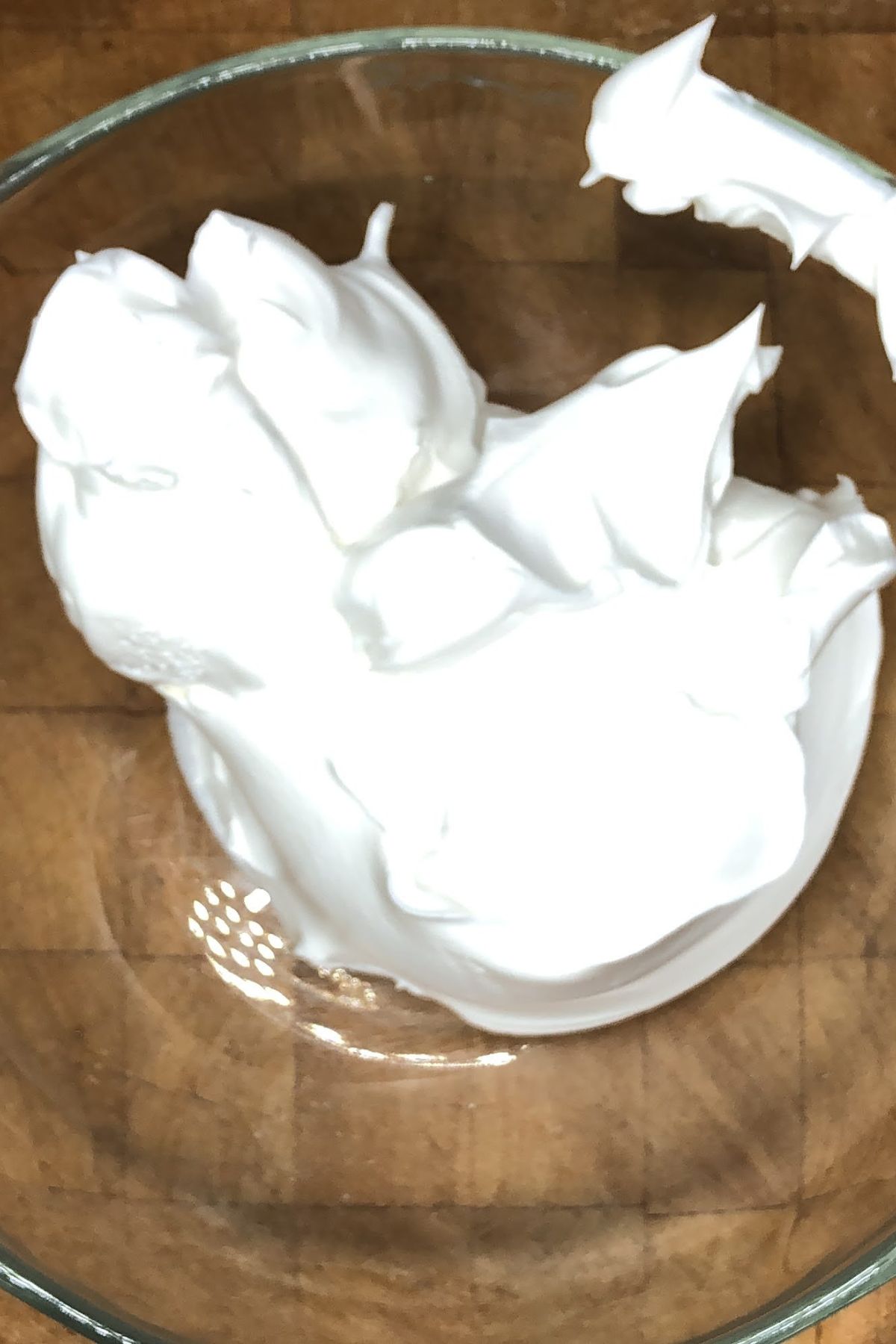 Adding whipped topping into bowl.