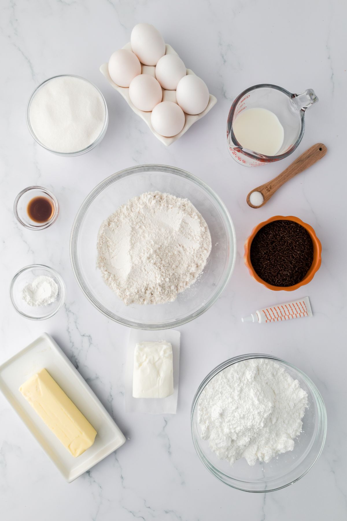 Ingredients for lunchbox cake on a marble background.