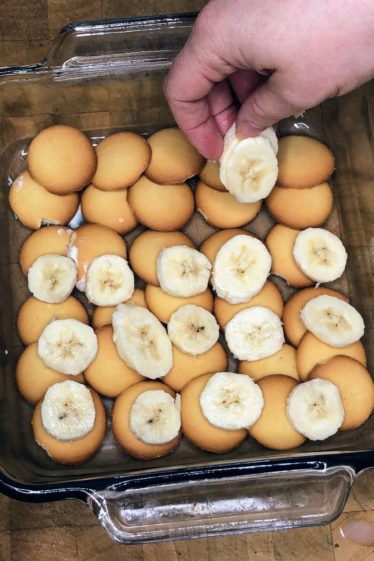 Placing banana slices on nilla wafers.