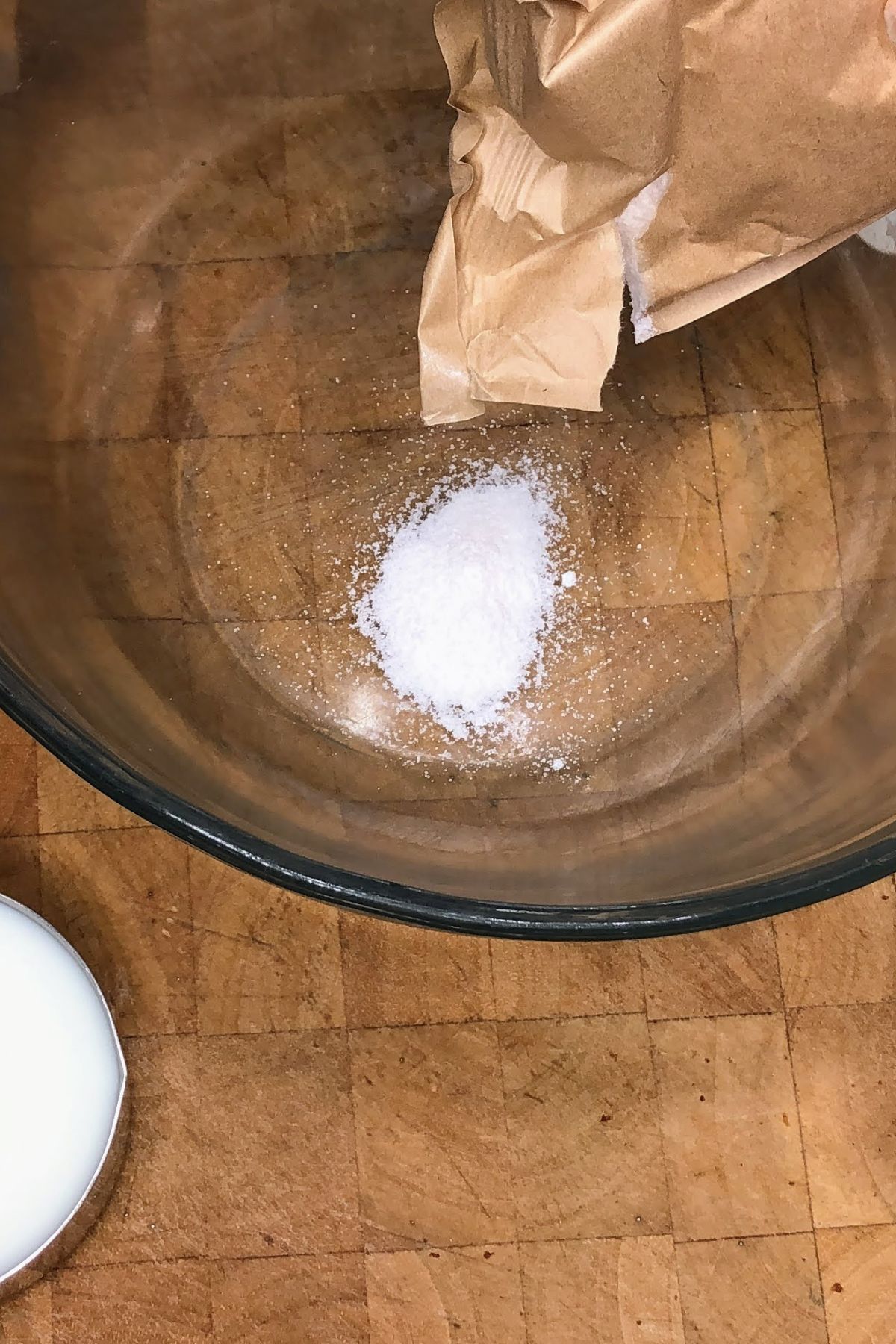 Pouring vanilla pudding into a mixing bowl.