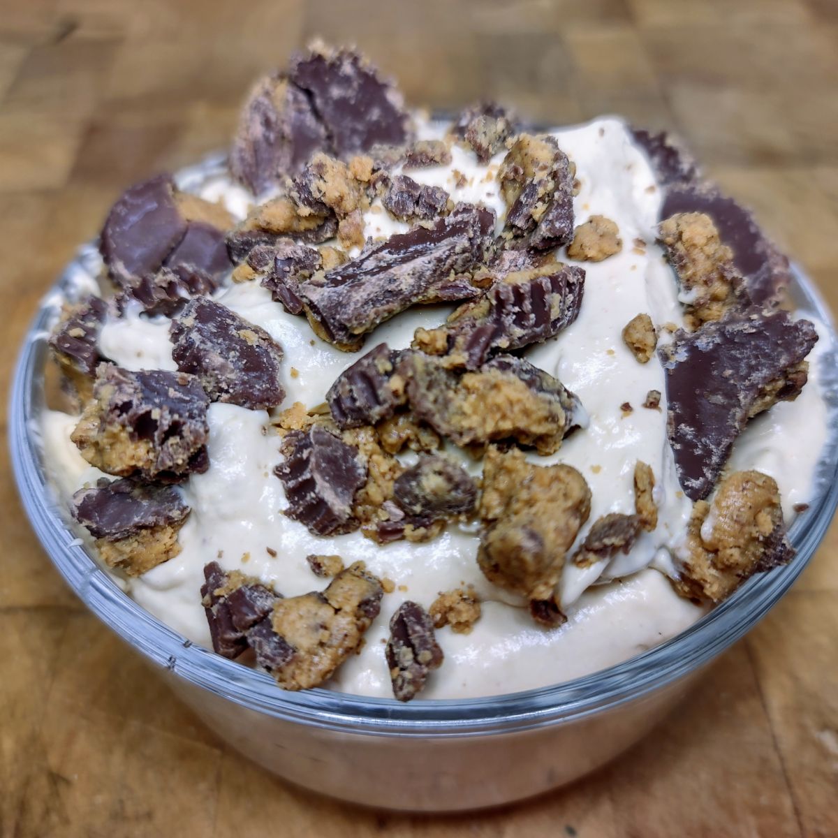 Peanut butter fluff in a bowl topped with crumbled peanut butter cups.