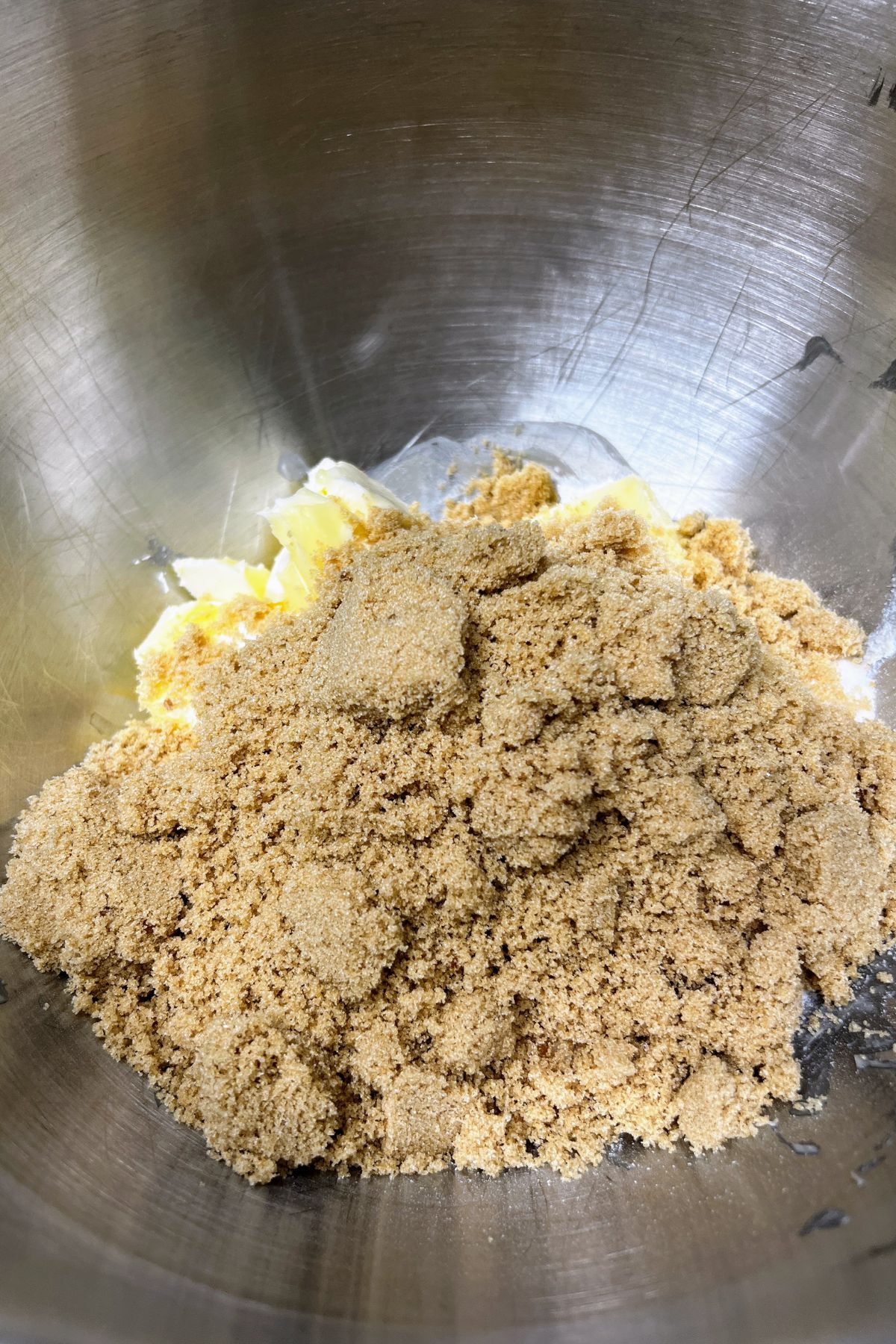 Butter, granulated and brown sugar in a mixing bowl.
