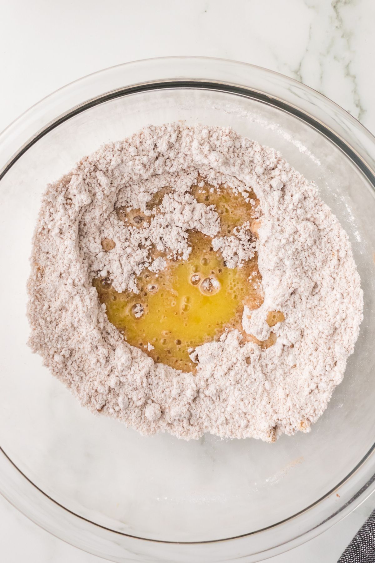 Mixing butter into crumble topping dry ingredients.