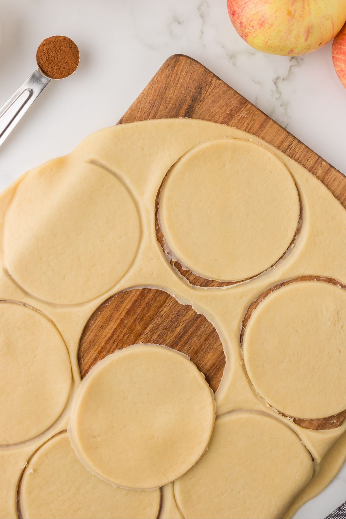 Cutting pie crust into circles for mini tarts.