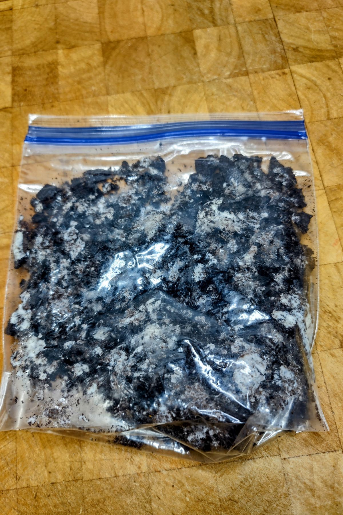 Crushed oreos in a ziplock bag.