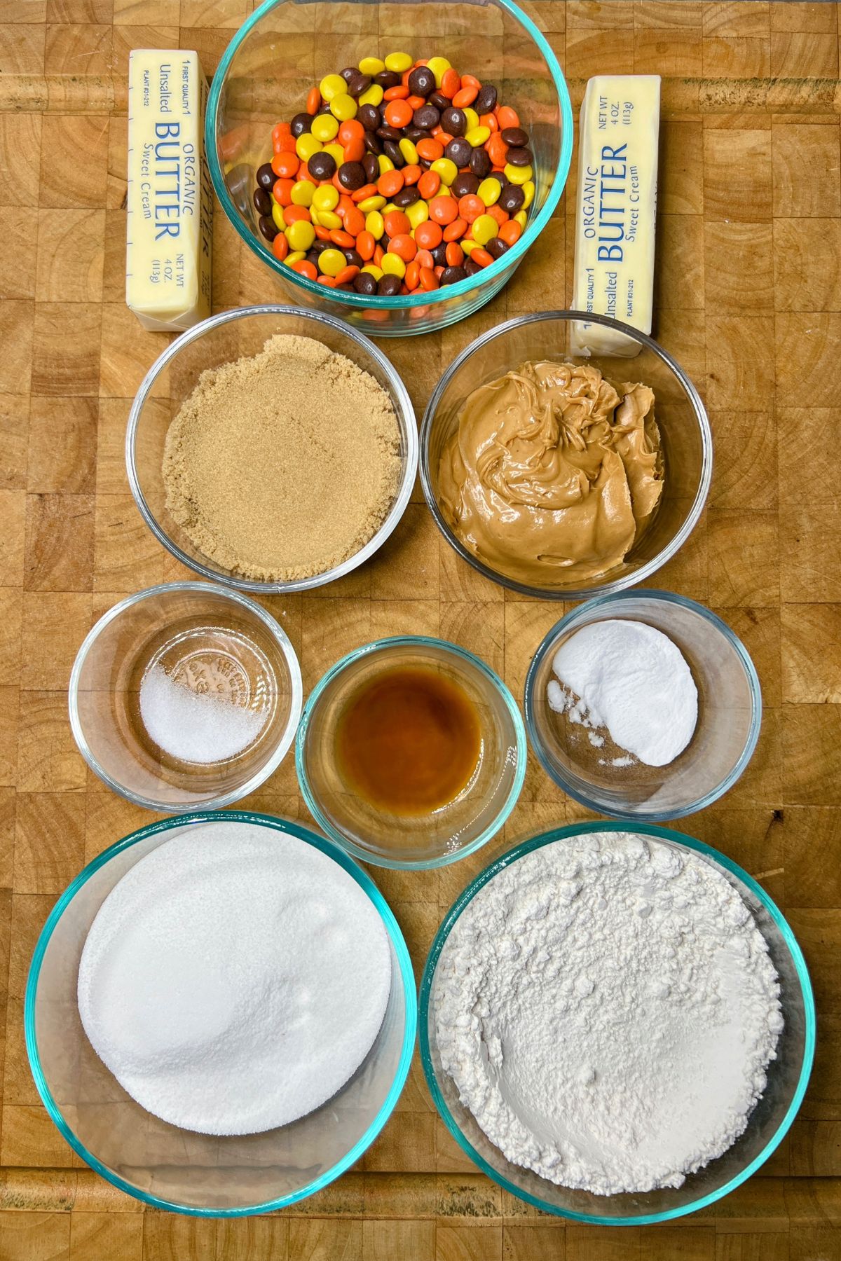 Reeses pieces peanut butter cookie ingredients on a wooden table.