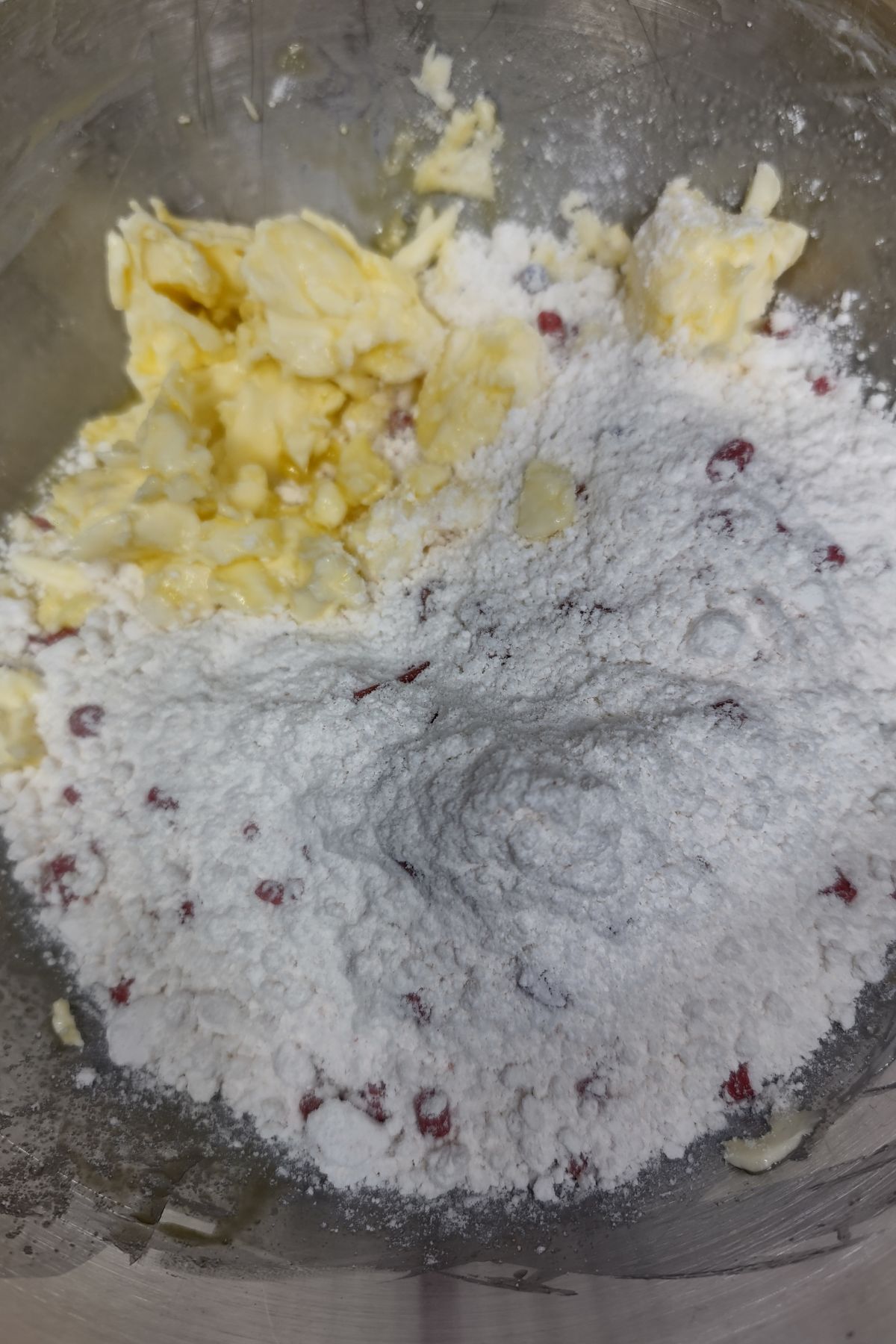 Muffin mix, eggs and butter in a mixing bowl.