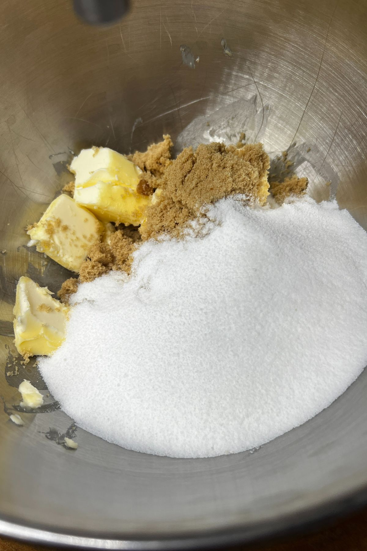 Mixing bowl with butter, white sugar and brown sugar.