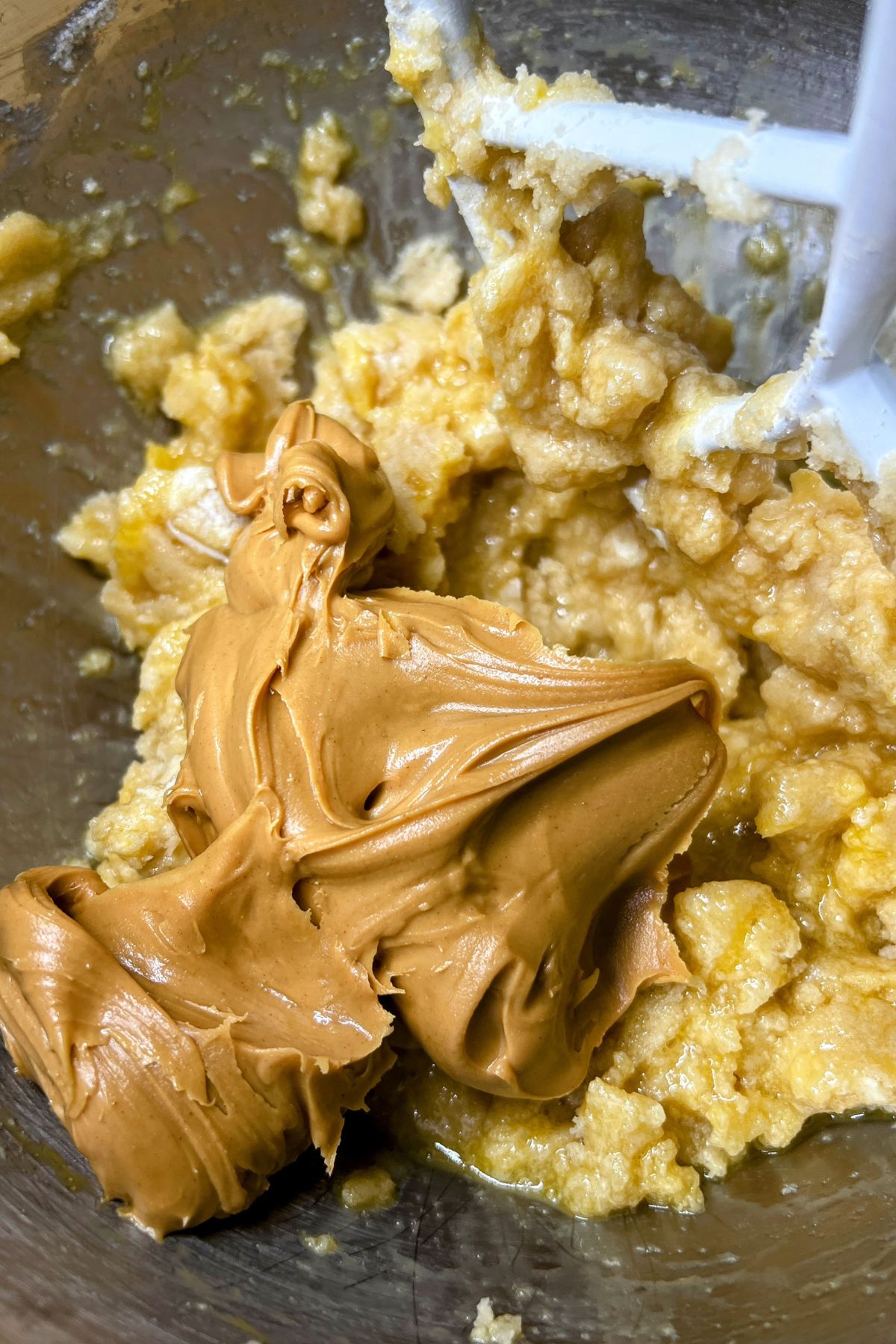 Peanut butter and eggs in a bowl with cookie dough.