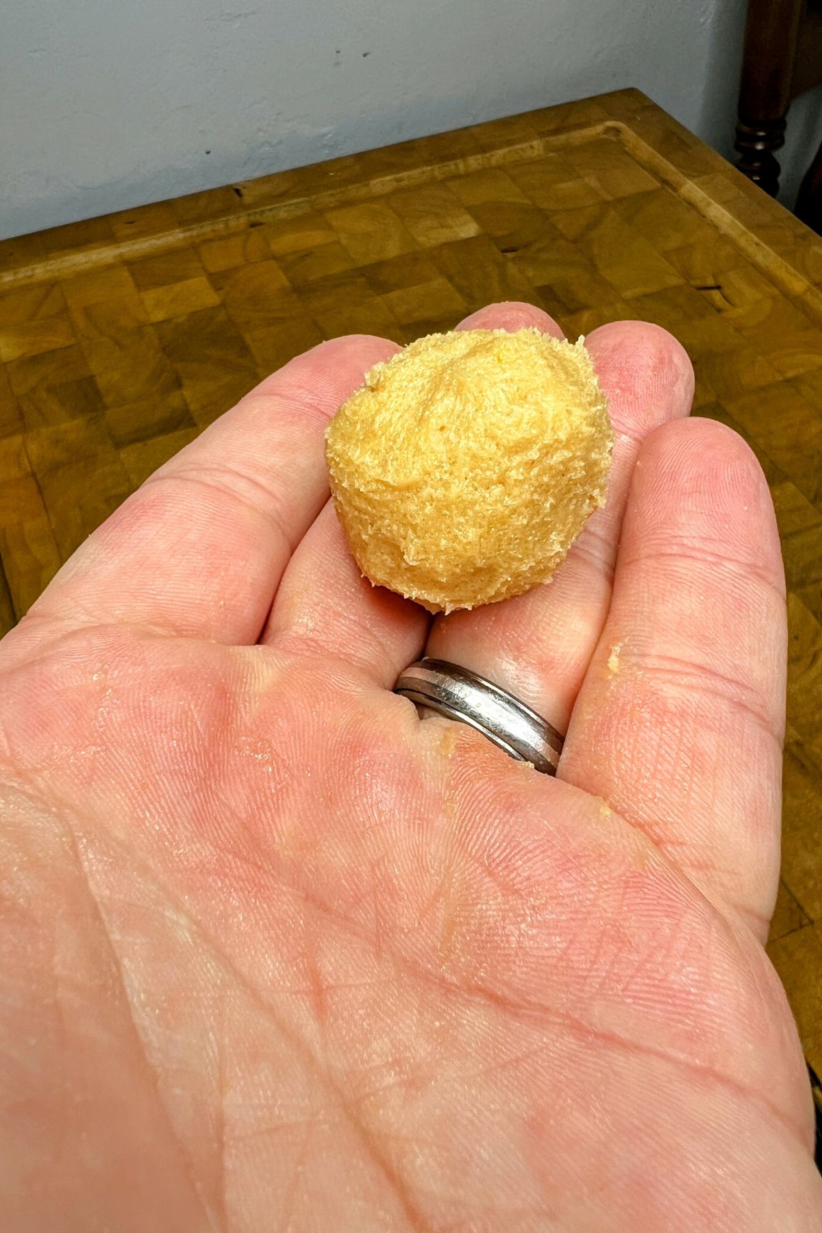 Pancake mix cookie dough ball in a hand.