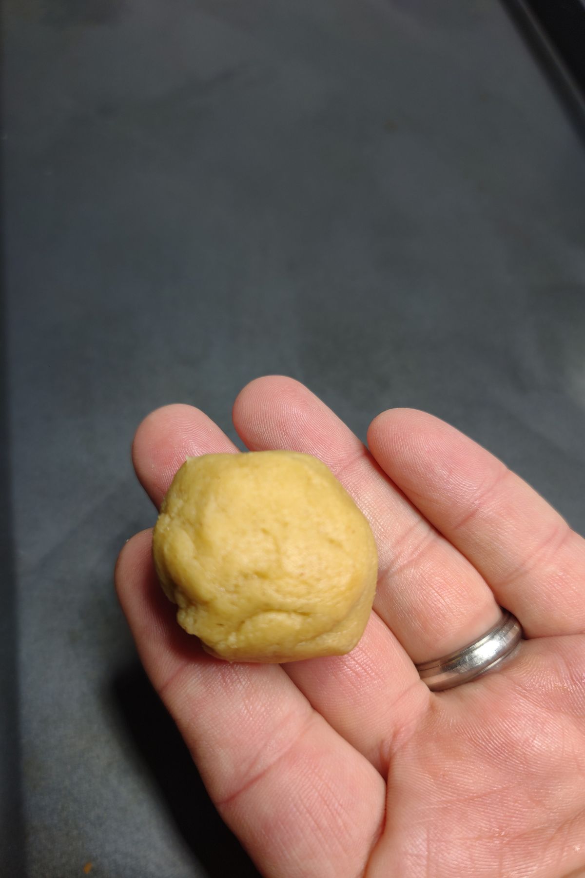 Ball of peanut butter cookie dough without brown sugar.