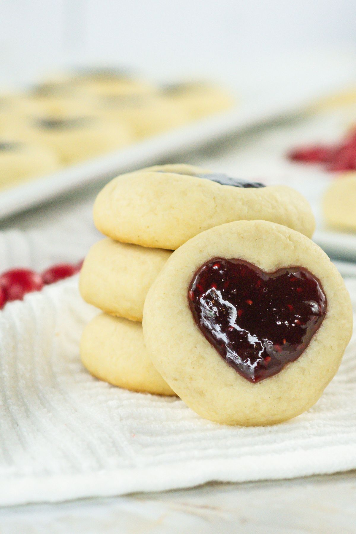 Stack of heart thumbprint cookies.