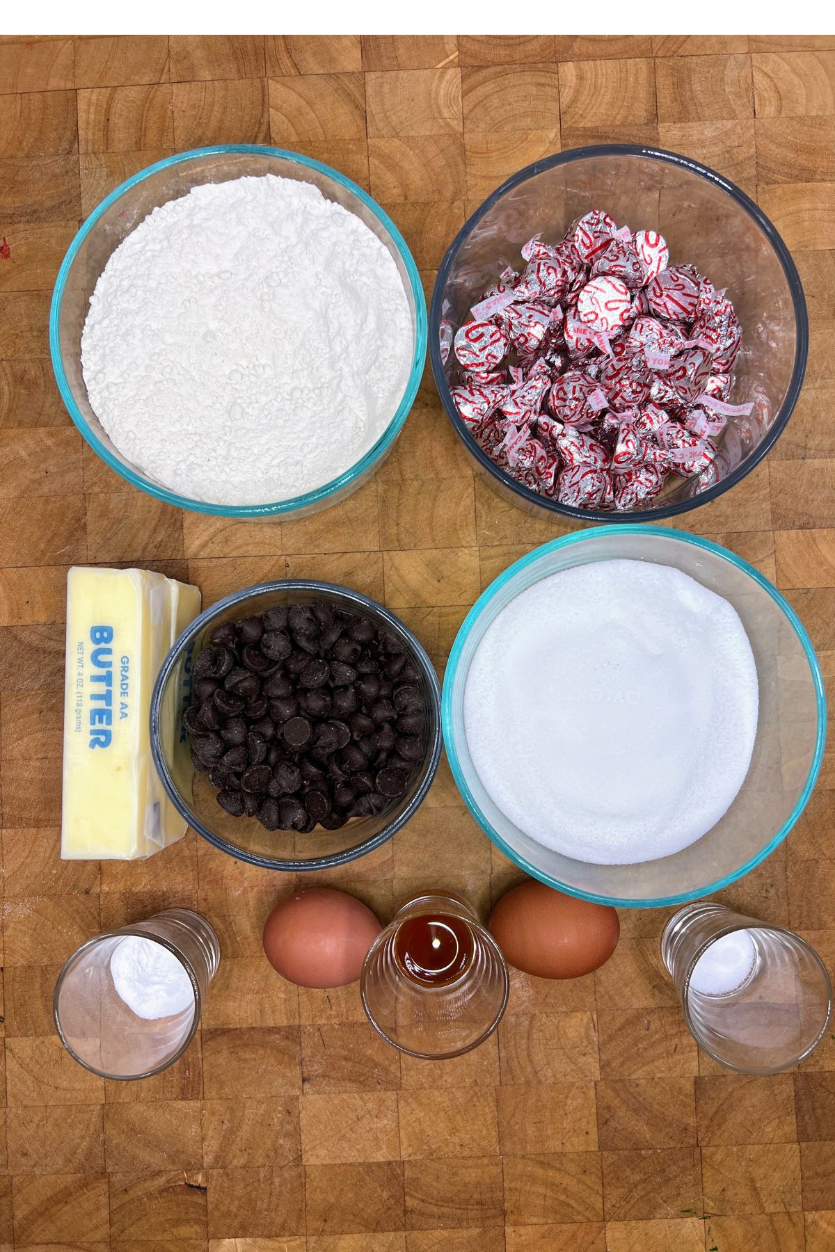 Ingredients for hershey kiss sugar cookies on a wooden table.
