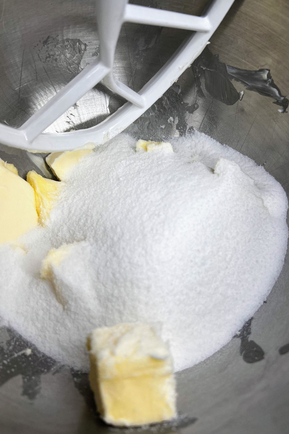 Granulated sugar and softened butter in a mixing bowl.
