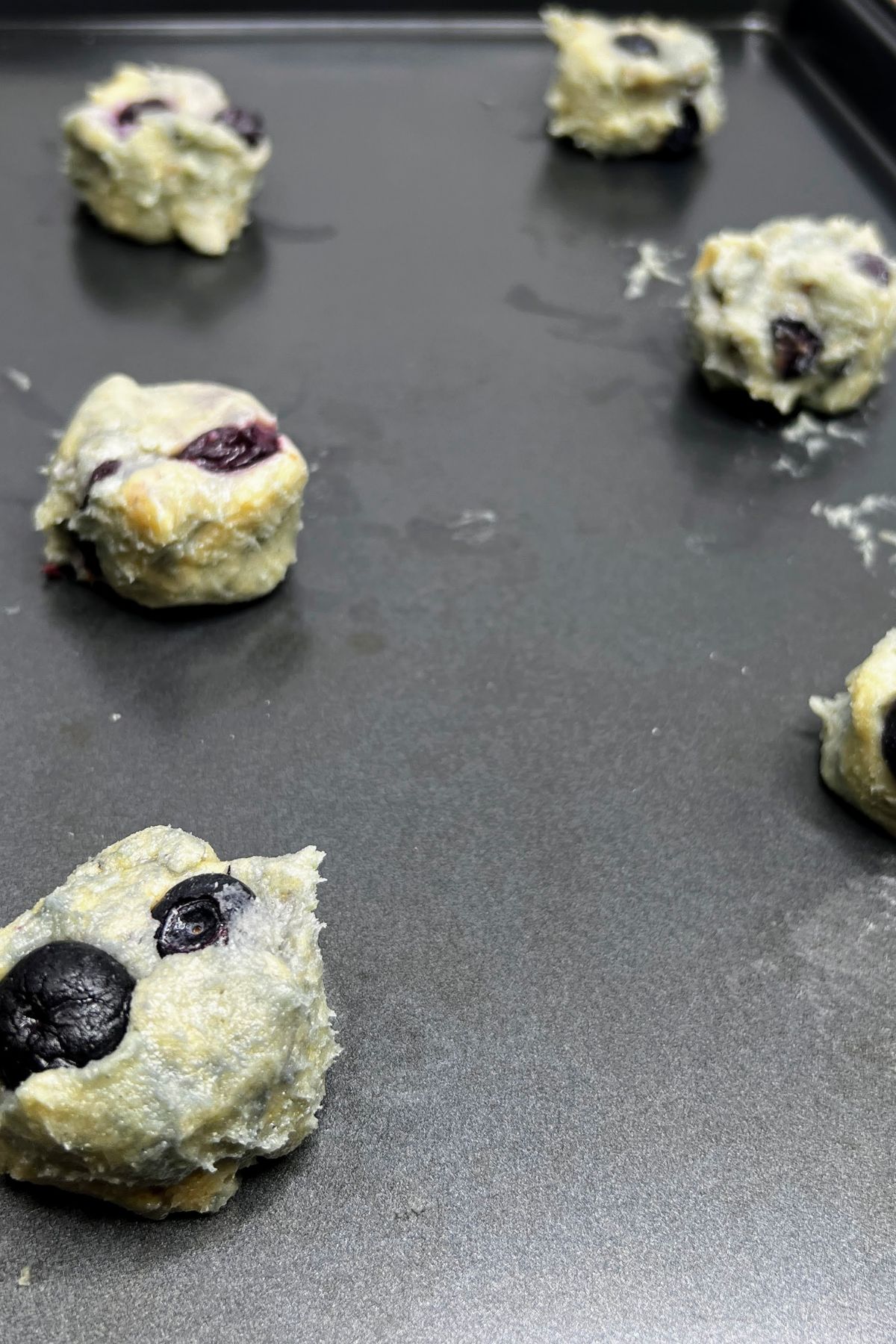 Lemon blueberry cookie dough on a baking sheet.