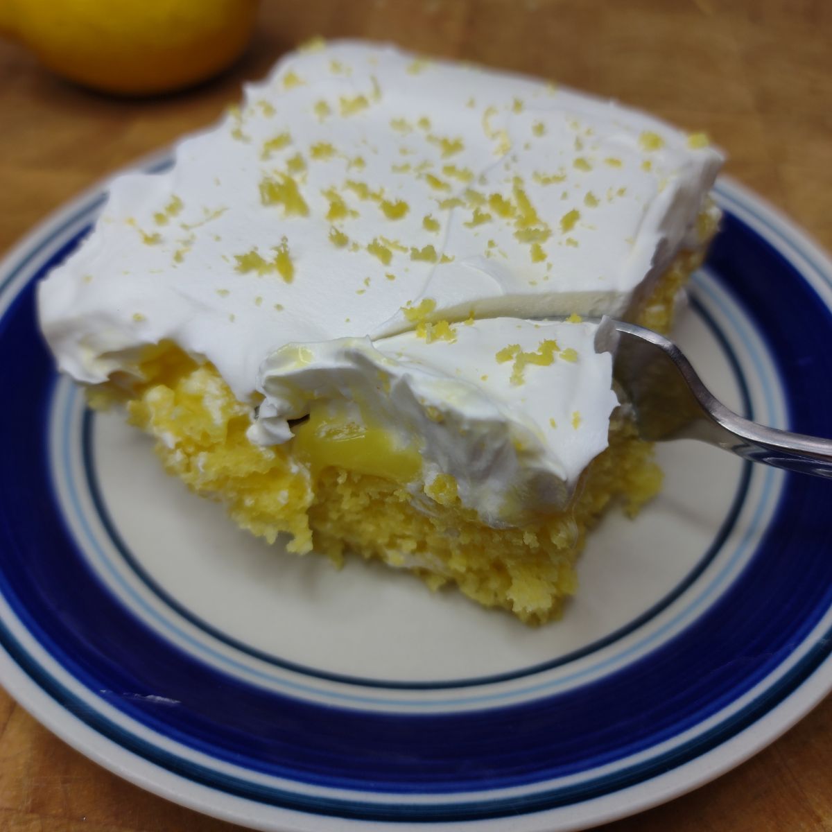 Lemon poke cake on a plate.