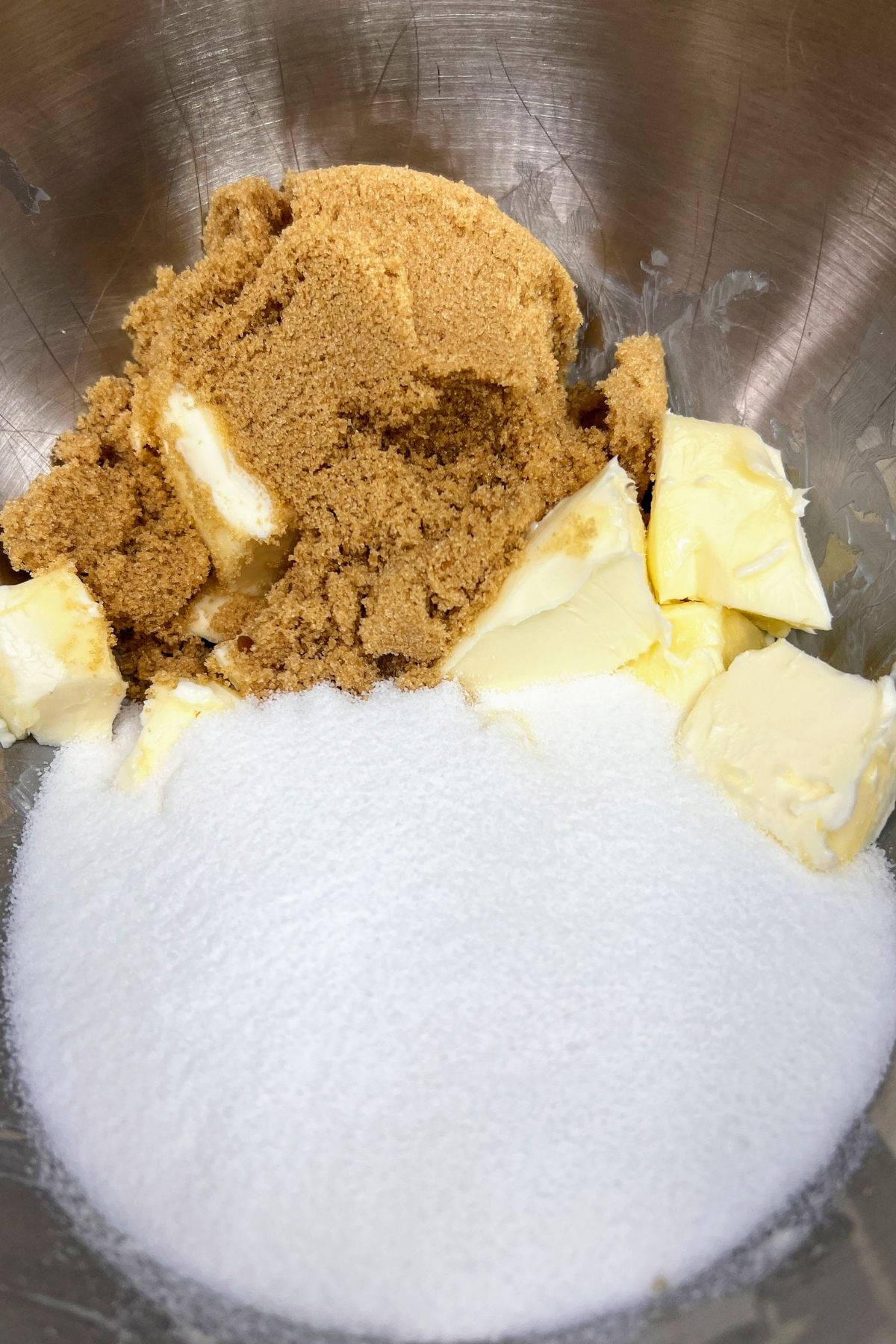 Softened butter with brown and white sugar in a mixing bowl.