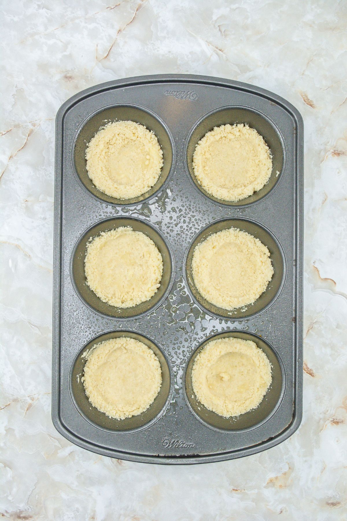 Cookie dough in muffin tins.
