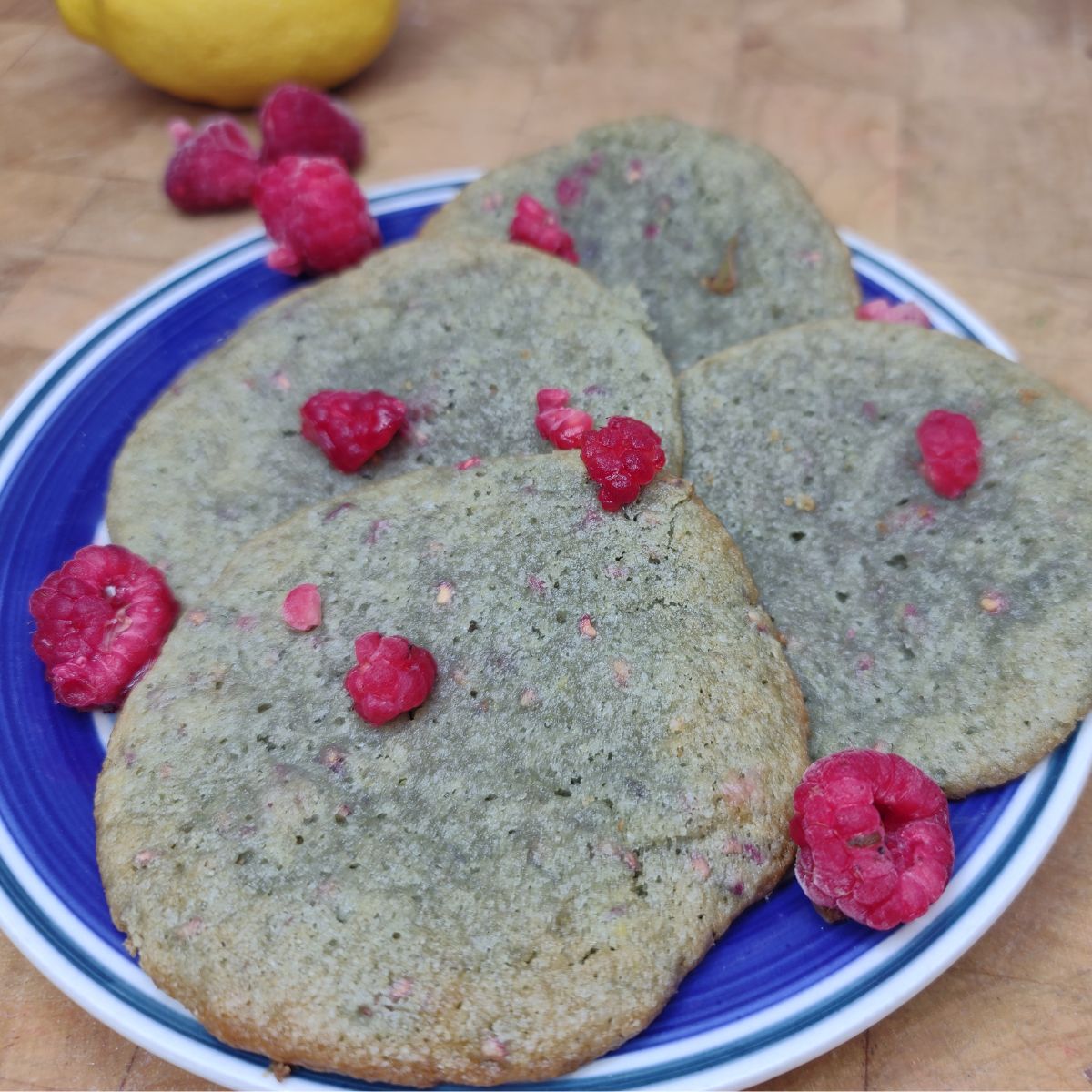 Plate of lemon raspberry cookies on a wooden table.