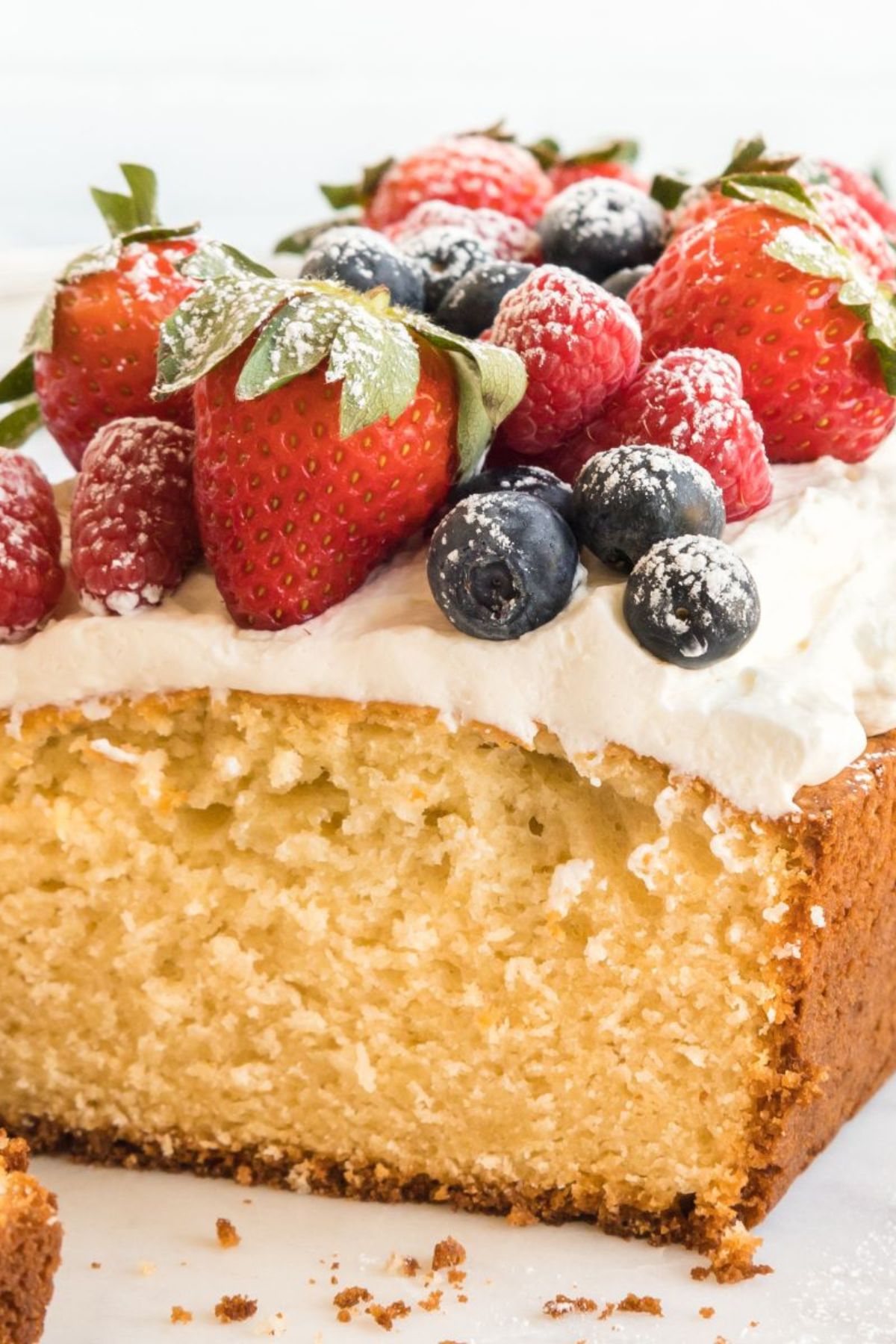 Whipped cream pound cake with berries on top.