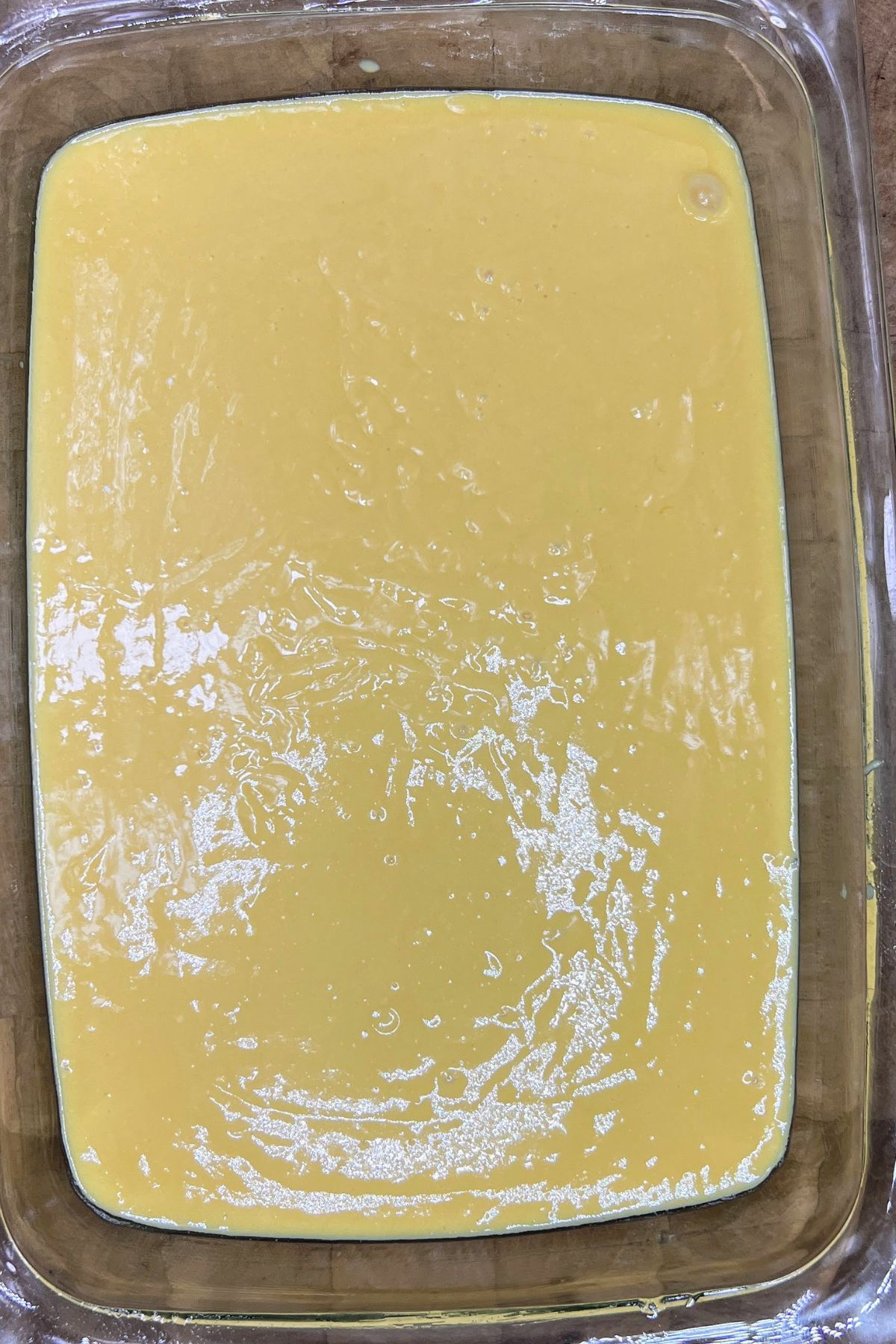 Yellow cake batter in a pan.